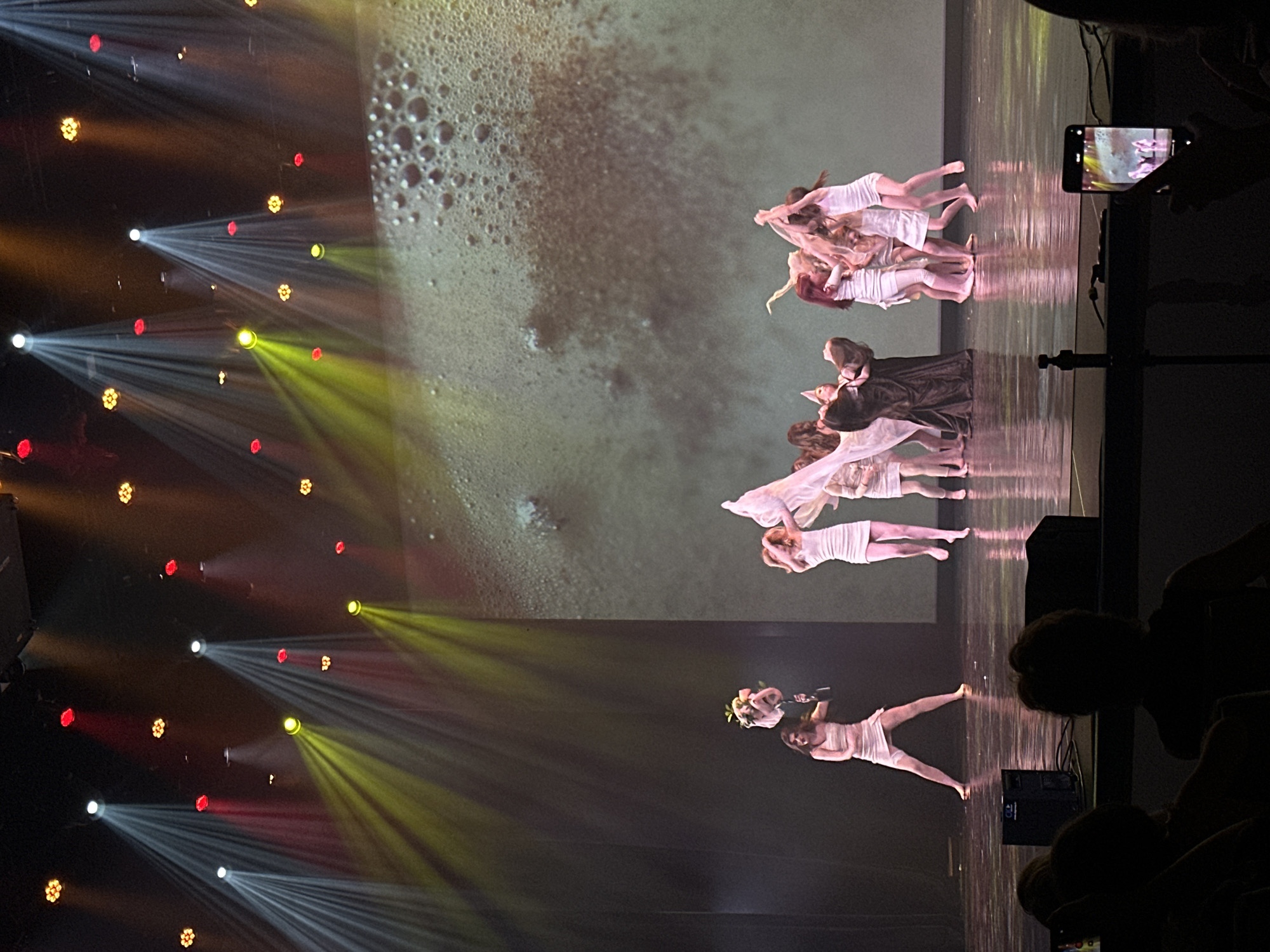 Contemporary dance performance on a dramatically lit Riga stage