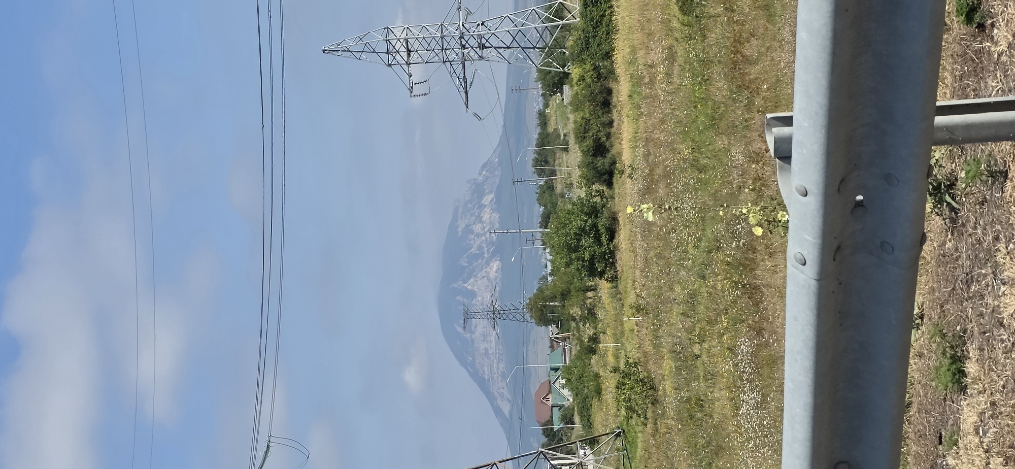 Hazy mountain looms over a quiet Russian village