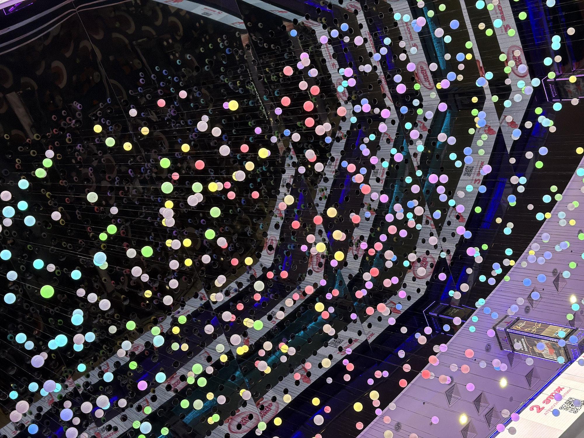 Witness captures geometric ceiling installation with perforated black panels