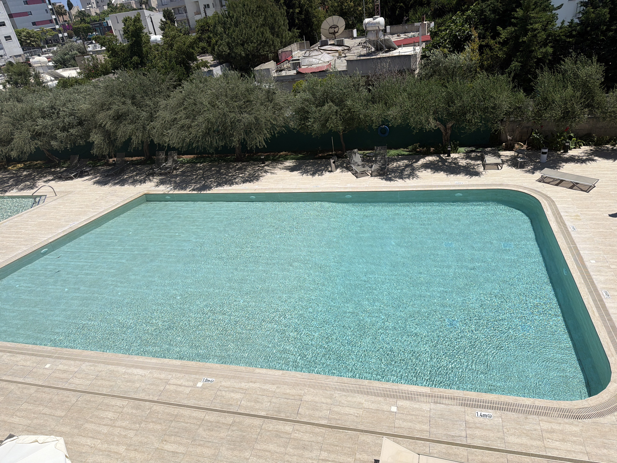 Woman sunbathes poolside at Cyprus recreational facility