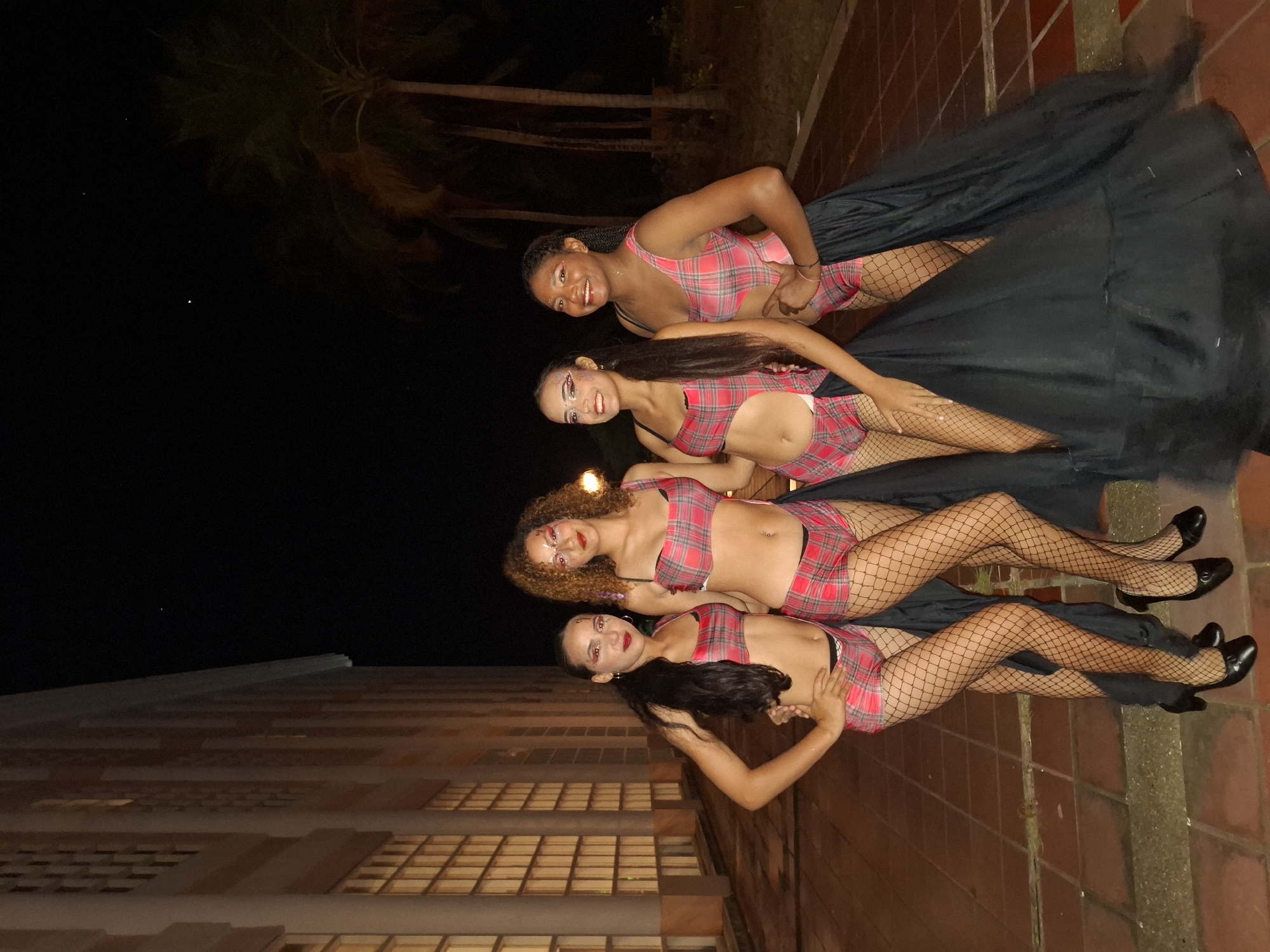 Costumed women gather for nighttime festivities in Pedro González, Venezuela