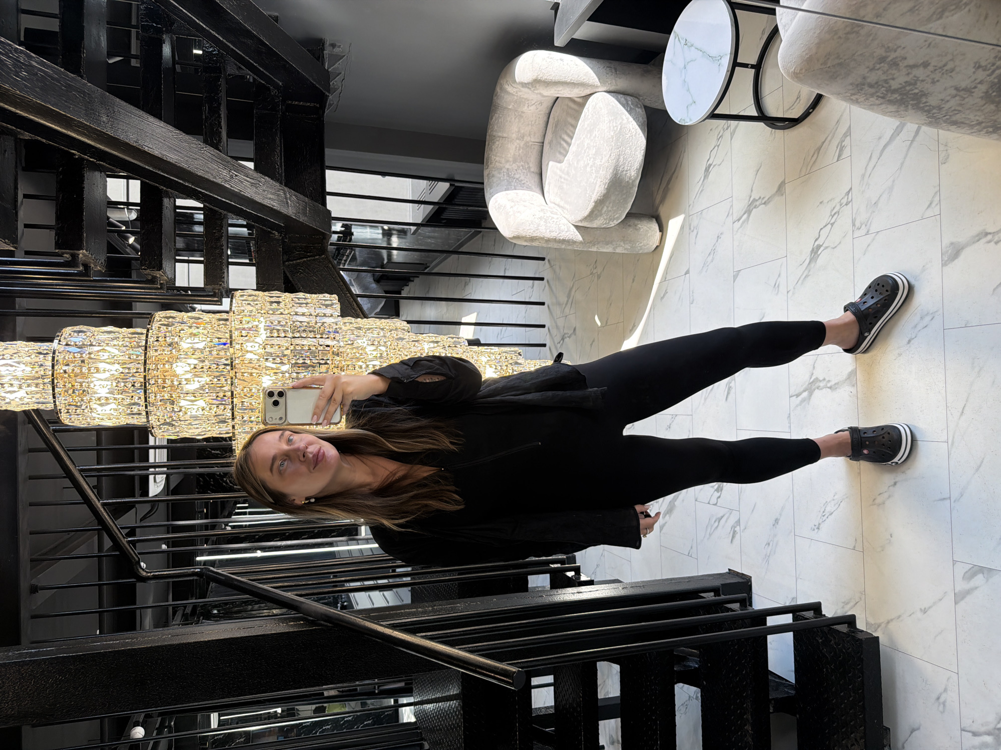 Woman takes multiple selfies in upscale venue interior
