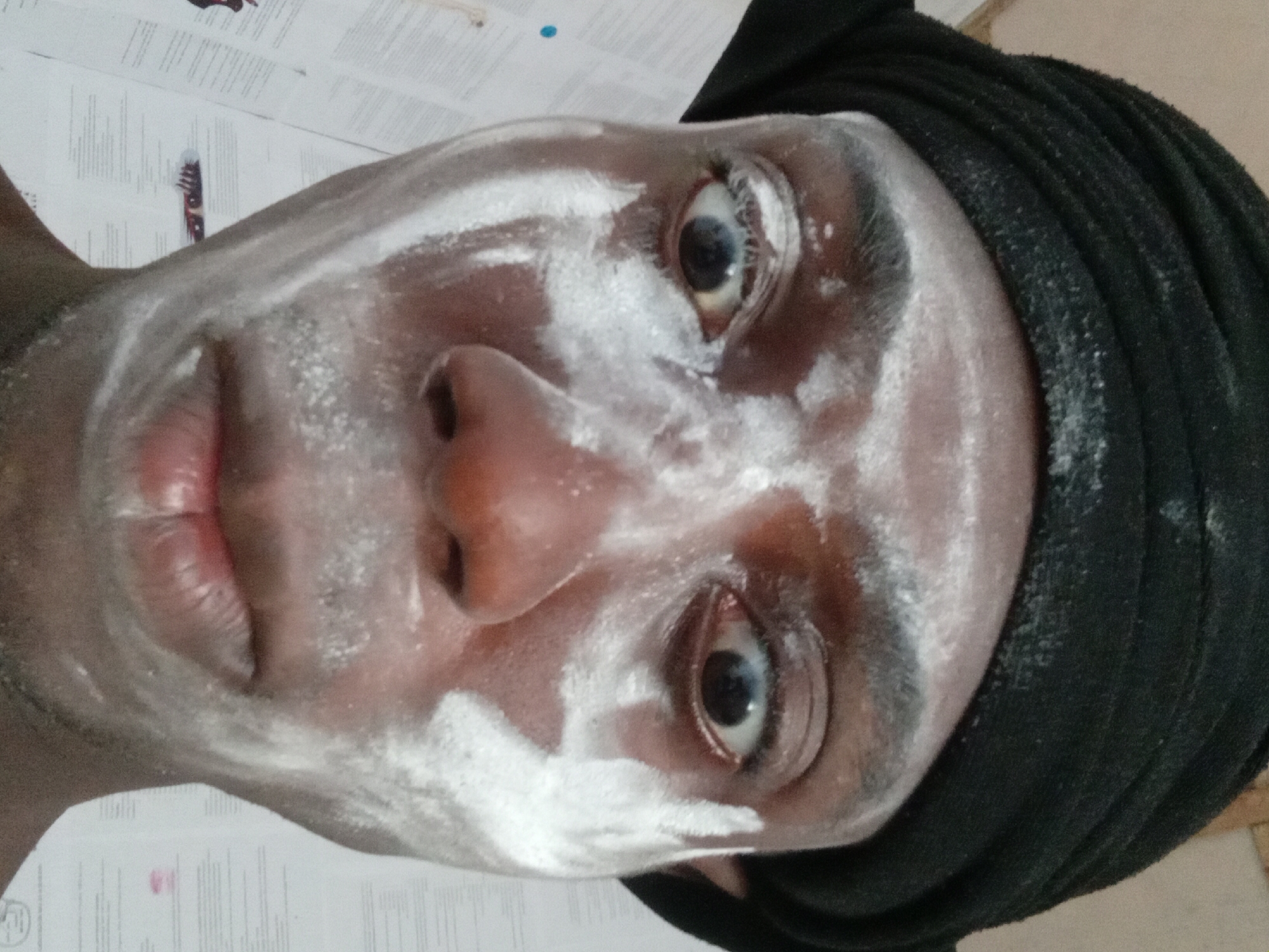 Person in Akwete applies face cream, supports collective memory