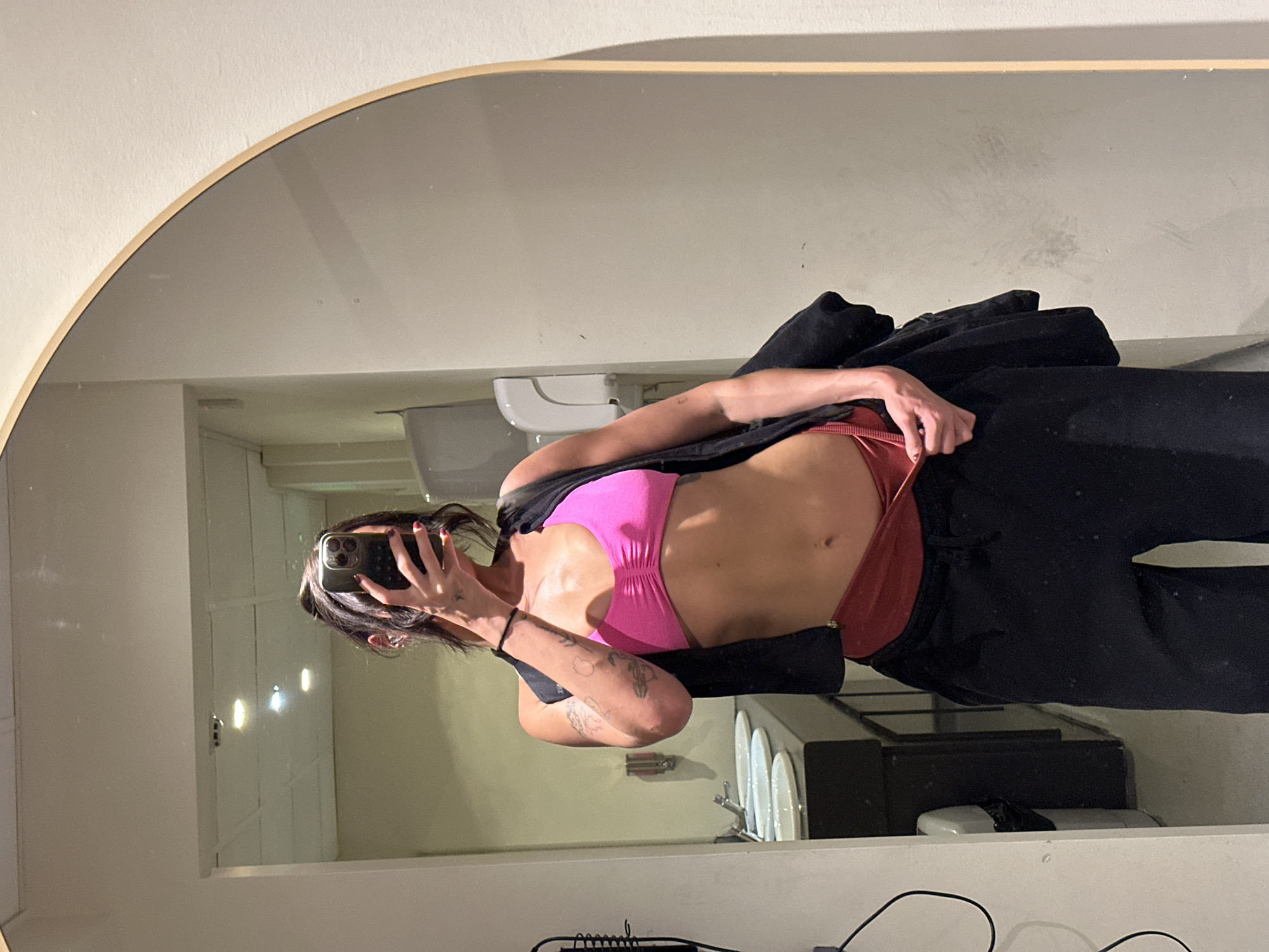 Woman takes mirror selfie in athletic wear, Tunbridge Wells