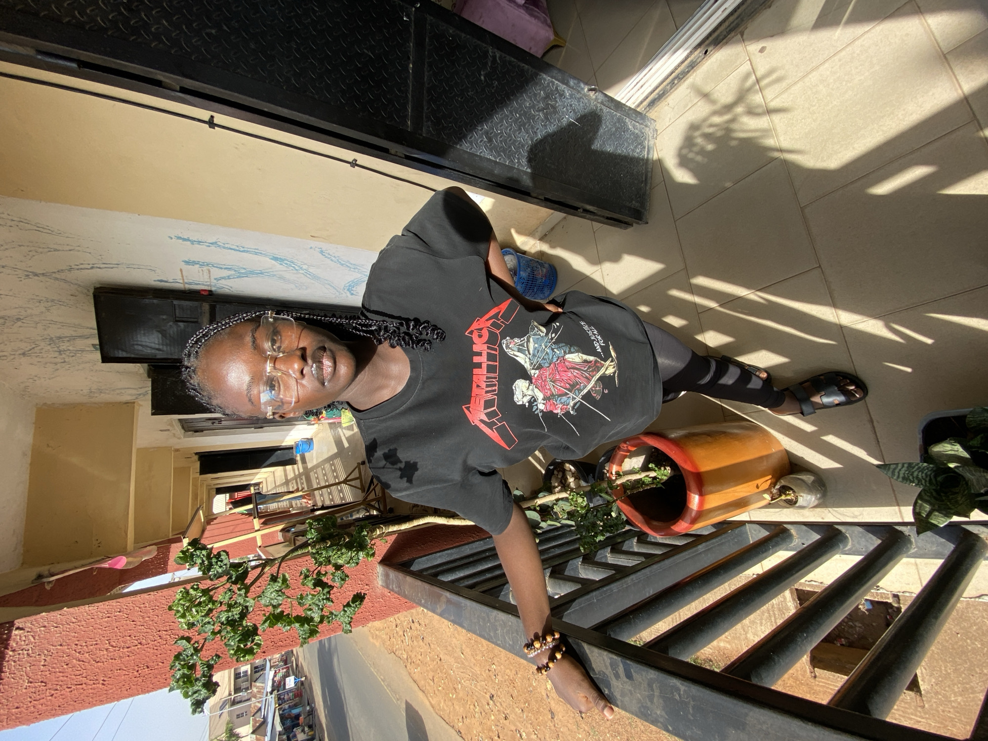 Woman in Metallica shirt captured in everyday moments in Bukuru