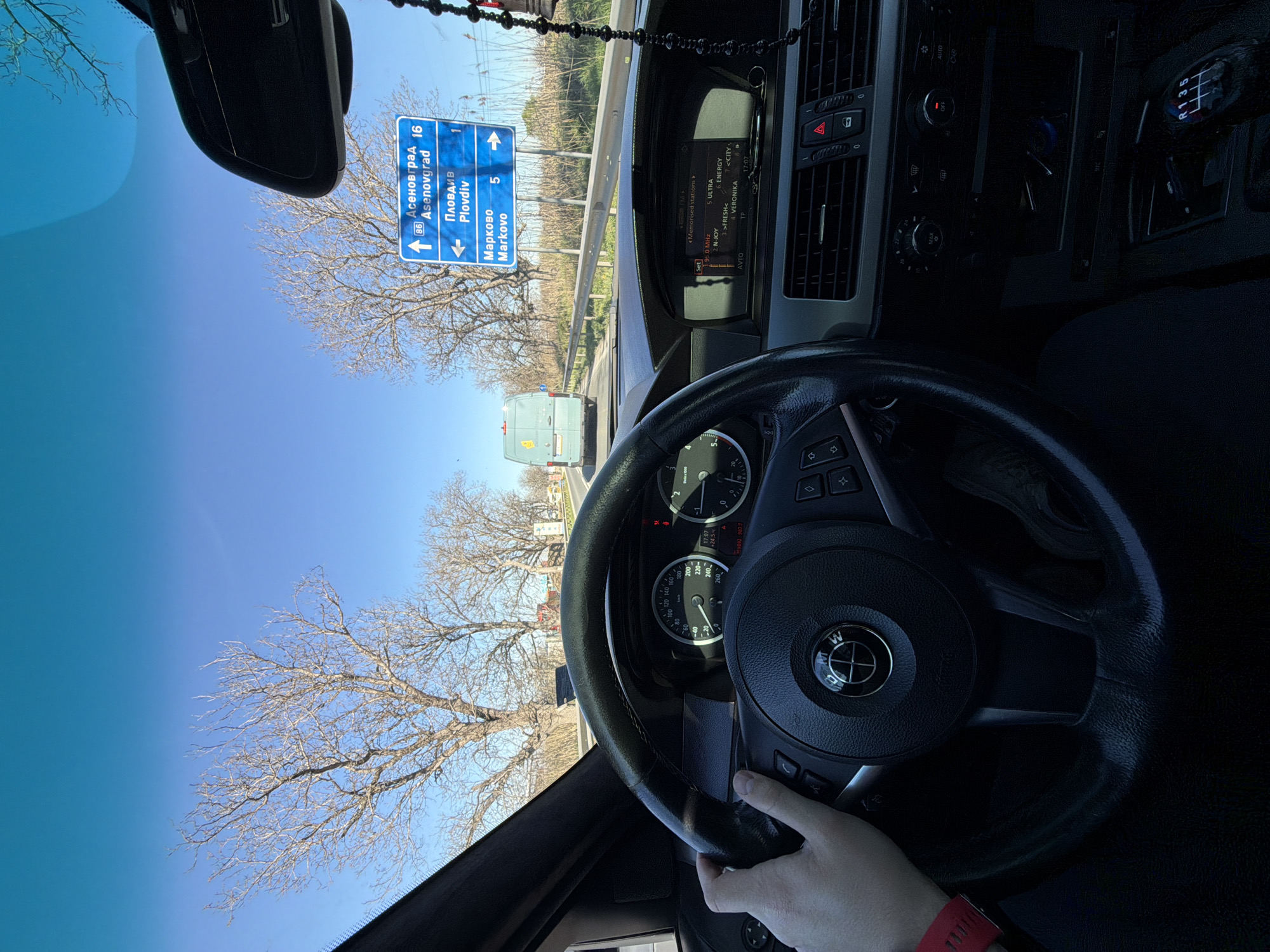 Motorist travels road approaching Plovdiv, Bulgaria under clear skies