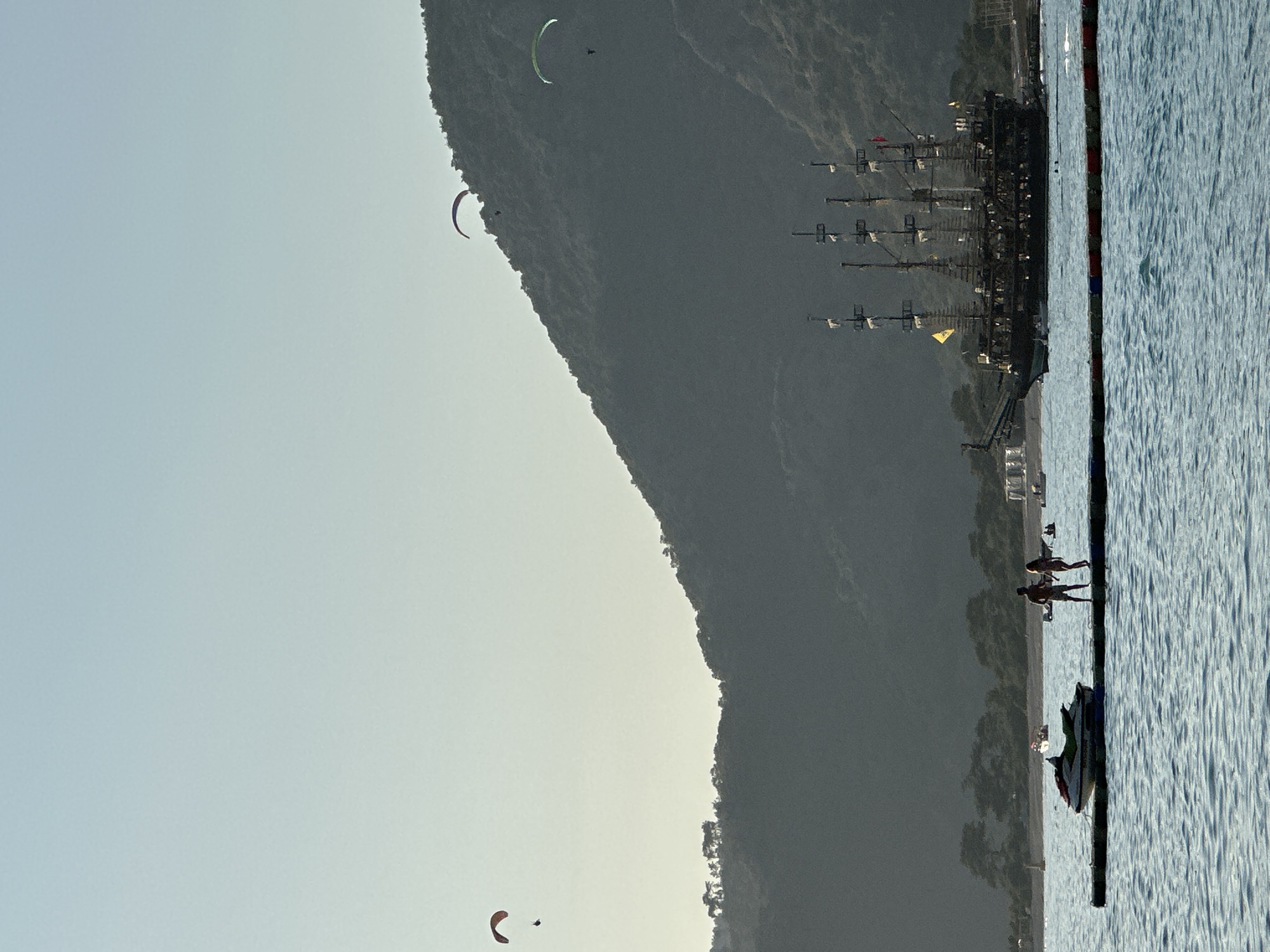 Paraglider lands, child plays in waves at Fethiye beach