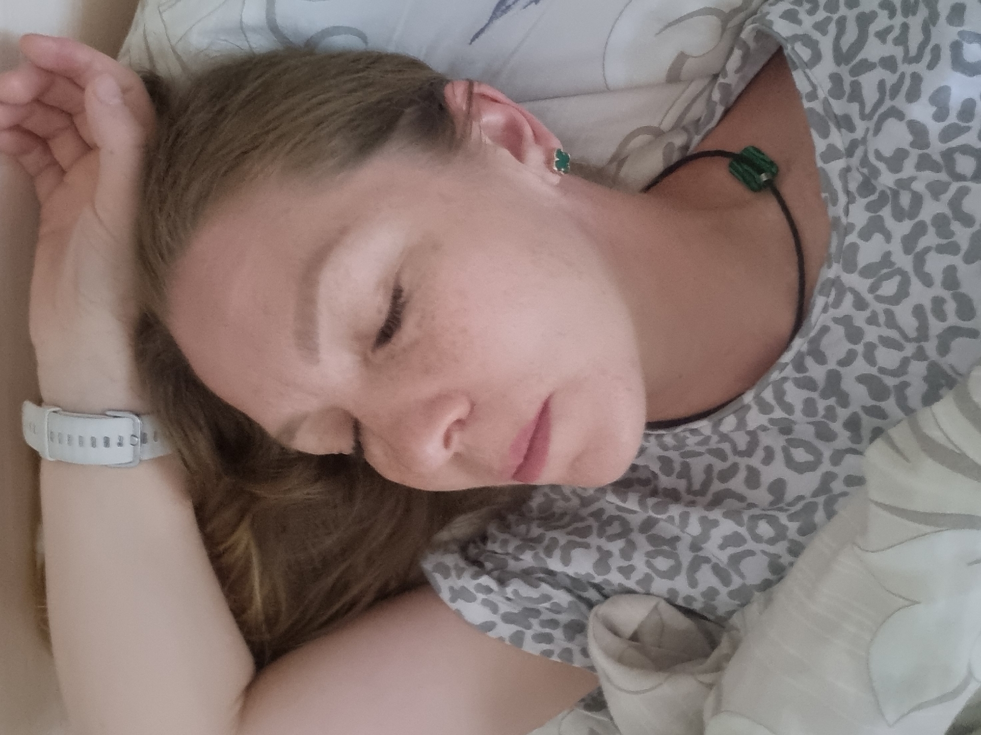 Woman rests in bed during early morning hours