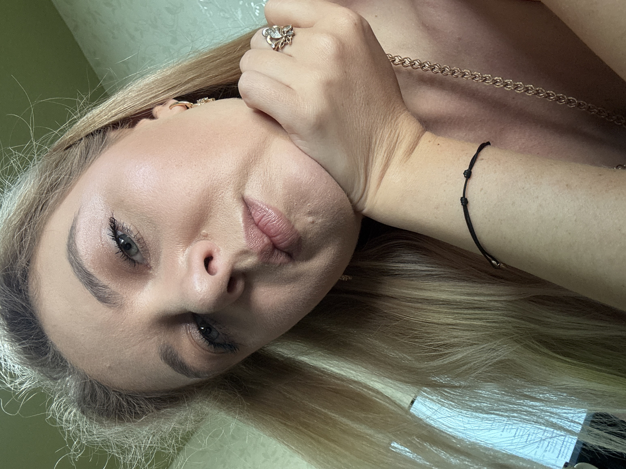 Indoor selfie session with red top and gold jewelry