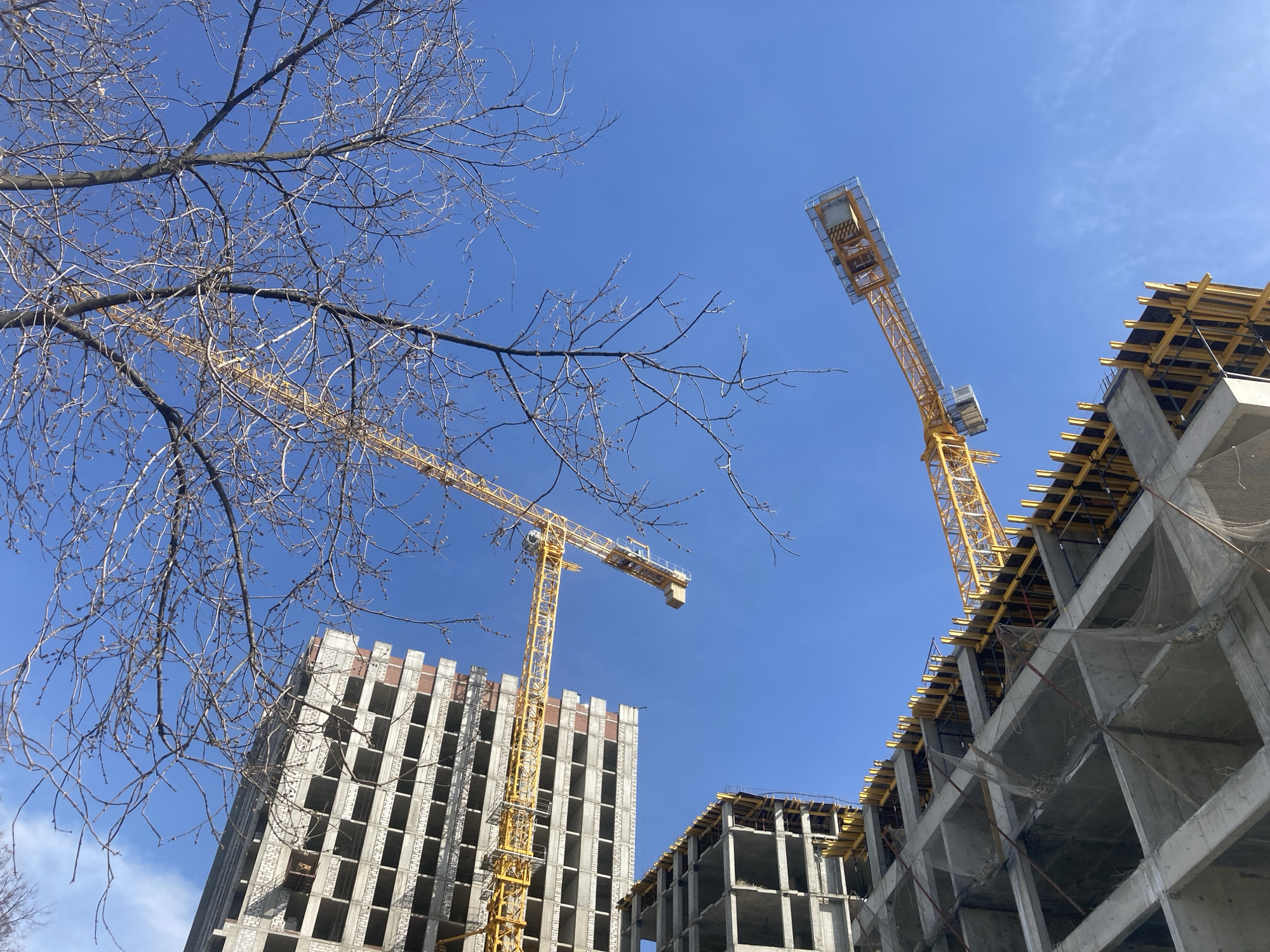 Construction cranes active at building site in Perm