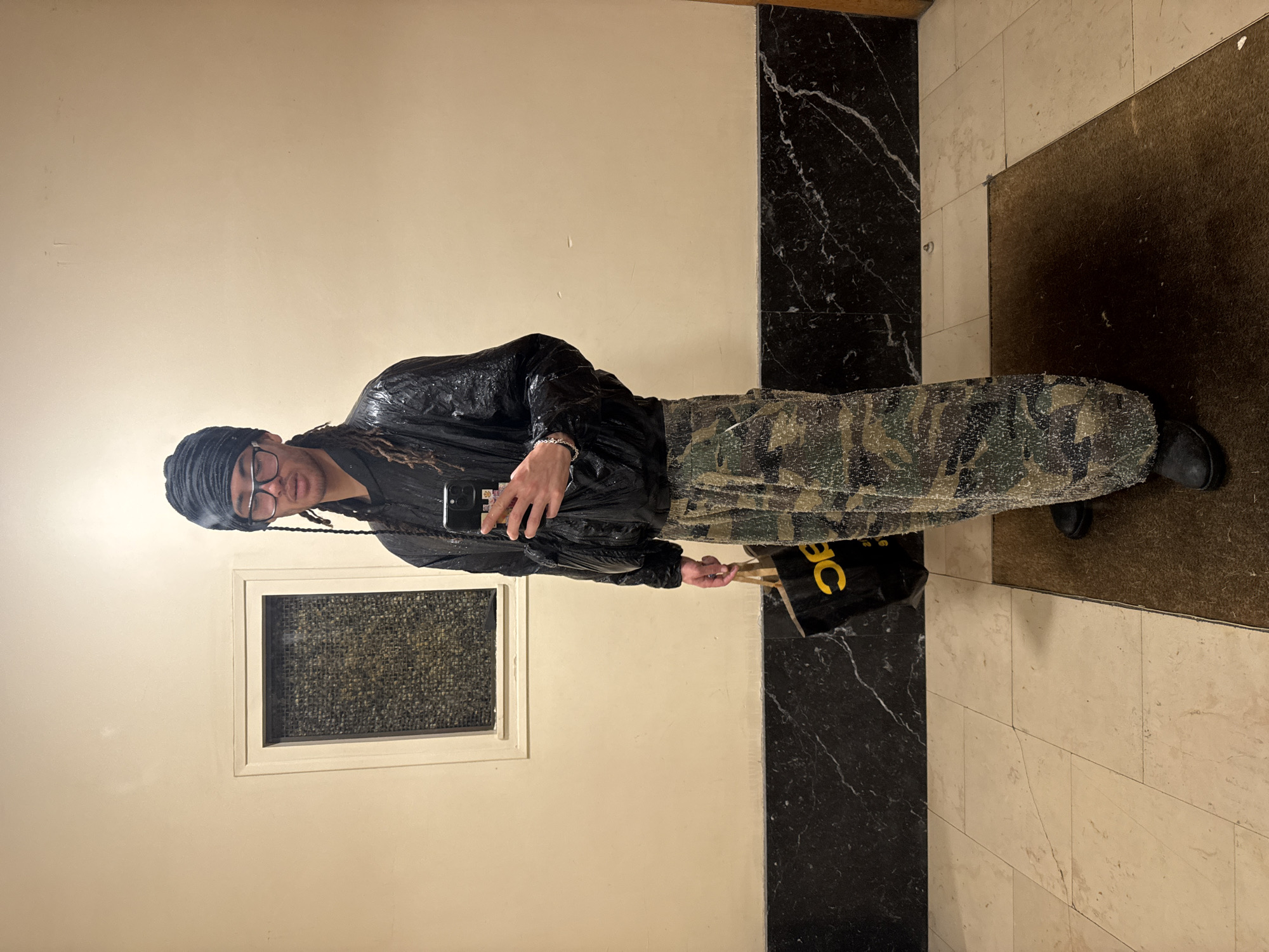 Person takes selfie in Paris building hallway