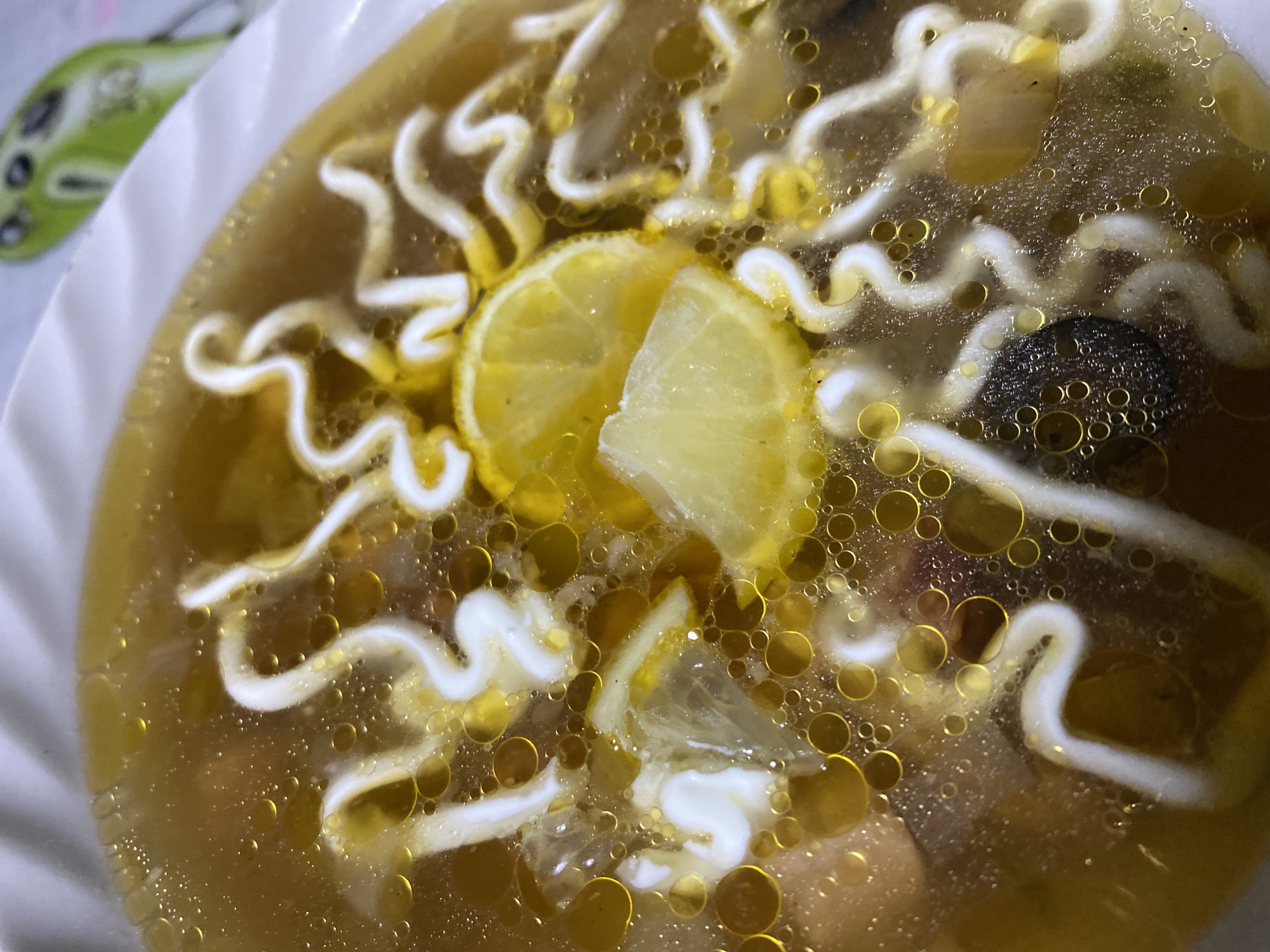 Bowl of broth soup with lemon observed in Noviy, Russia