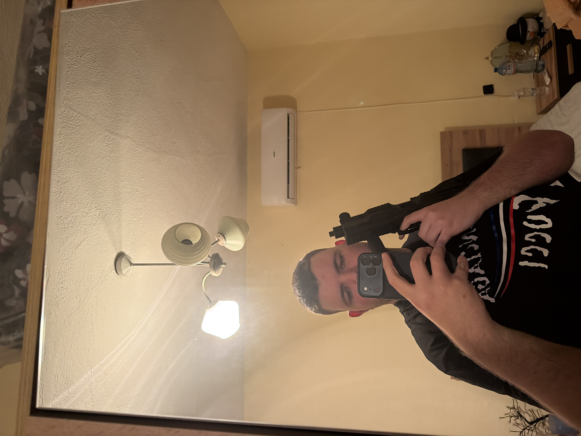 Person takes mirror selfie while holding firearm in Bulgaria