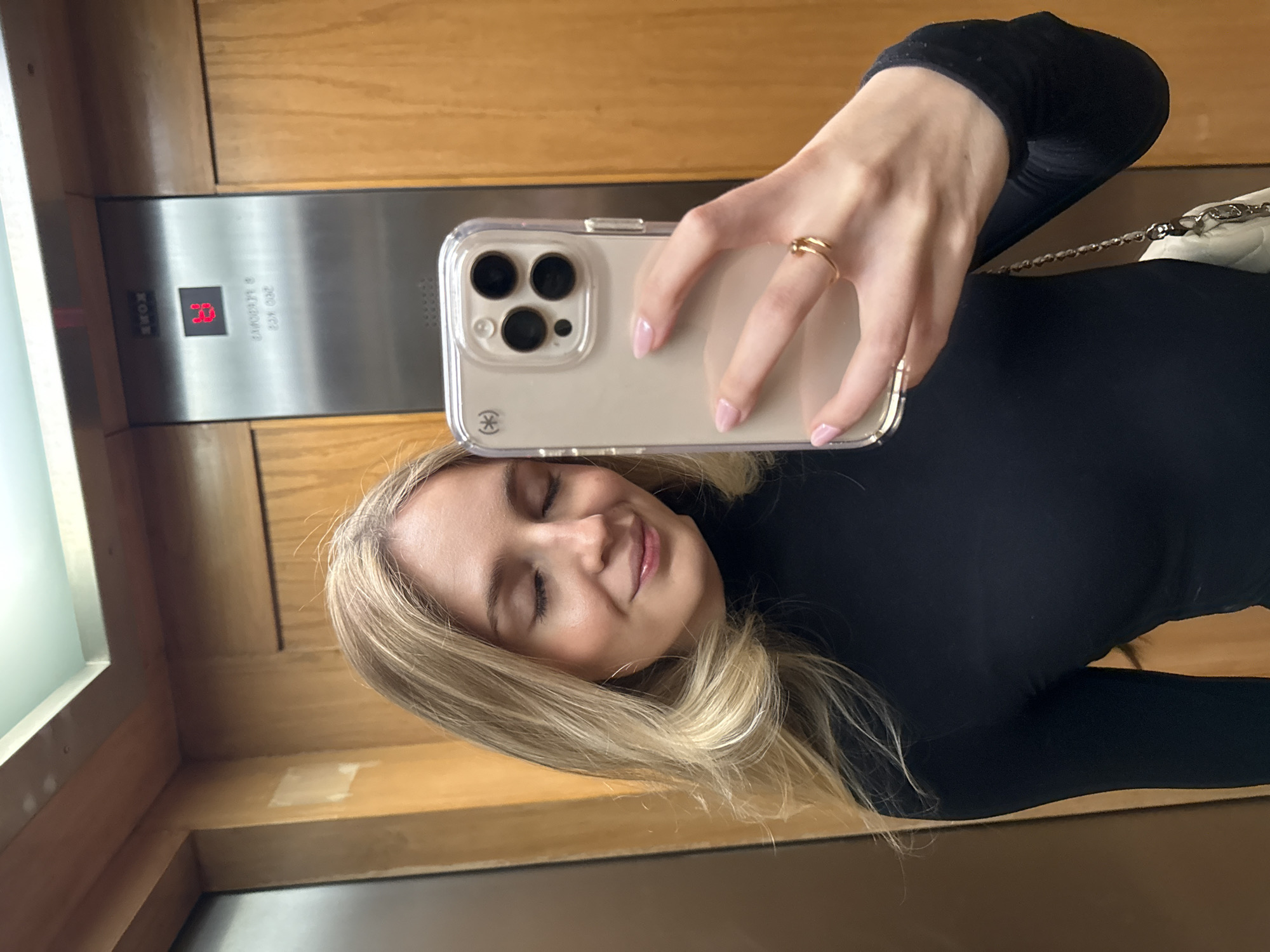 Woman takes selfie in Mexico City elevator at floor 13