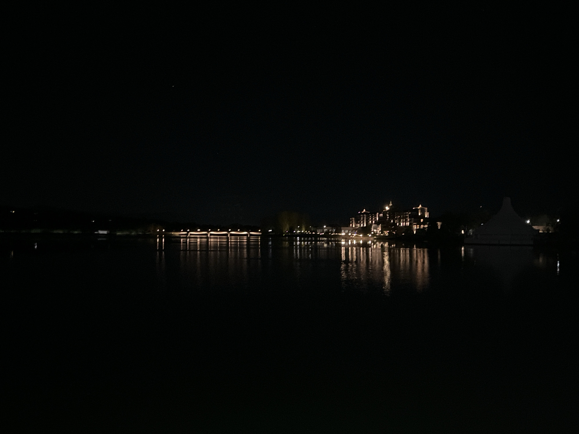 Nighttime scenes captured in Pravets, Bulgaria show waterfront buildings, city entrance