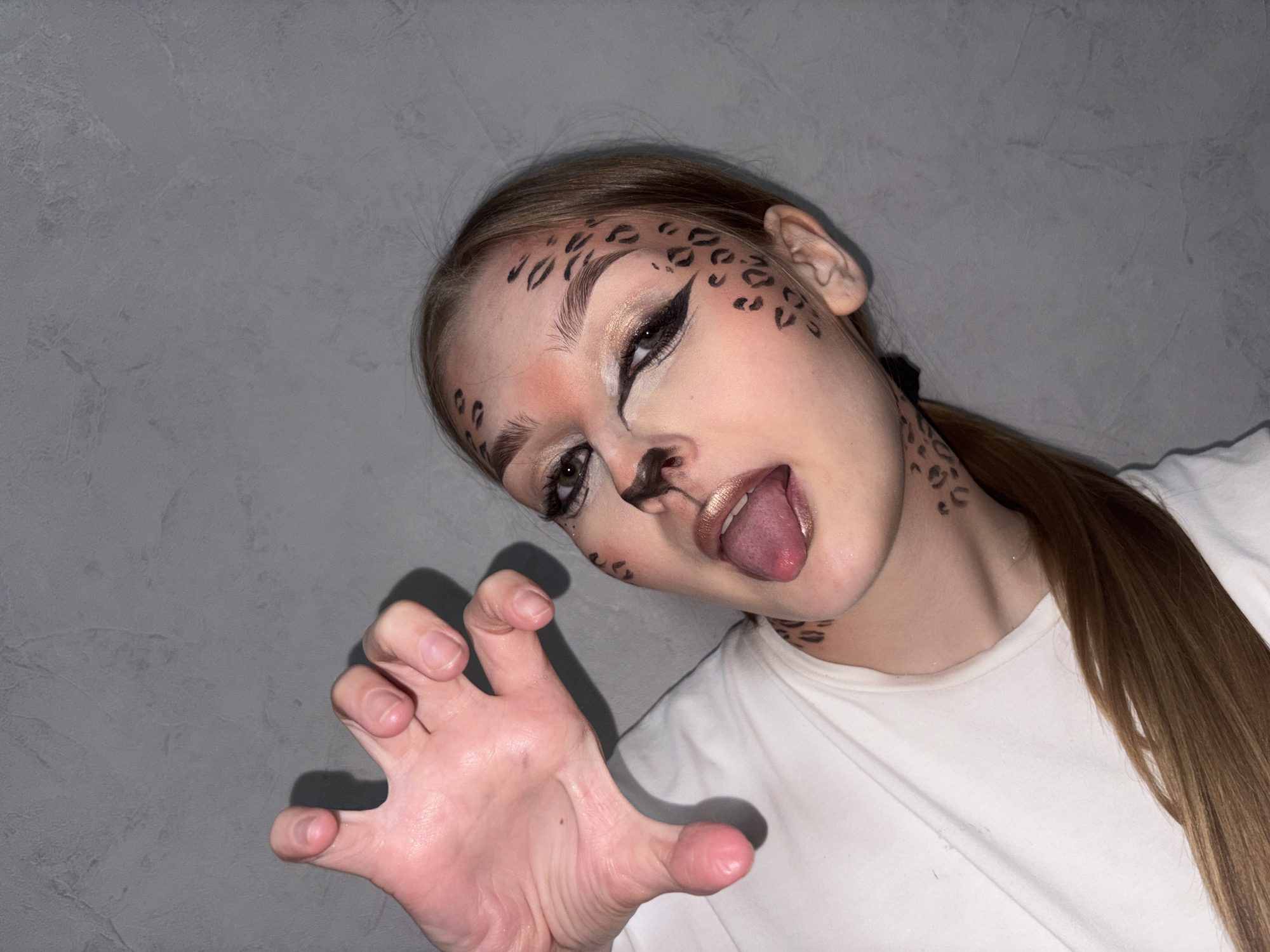Woman sports cheetah face paint in Chaikovsky selfie session