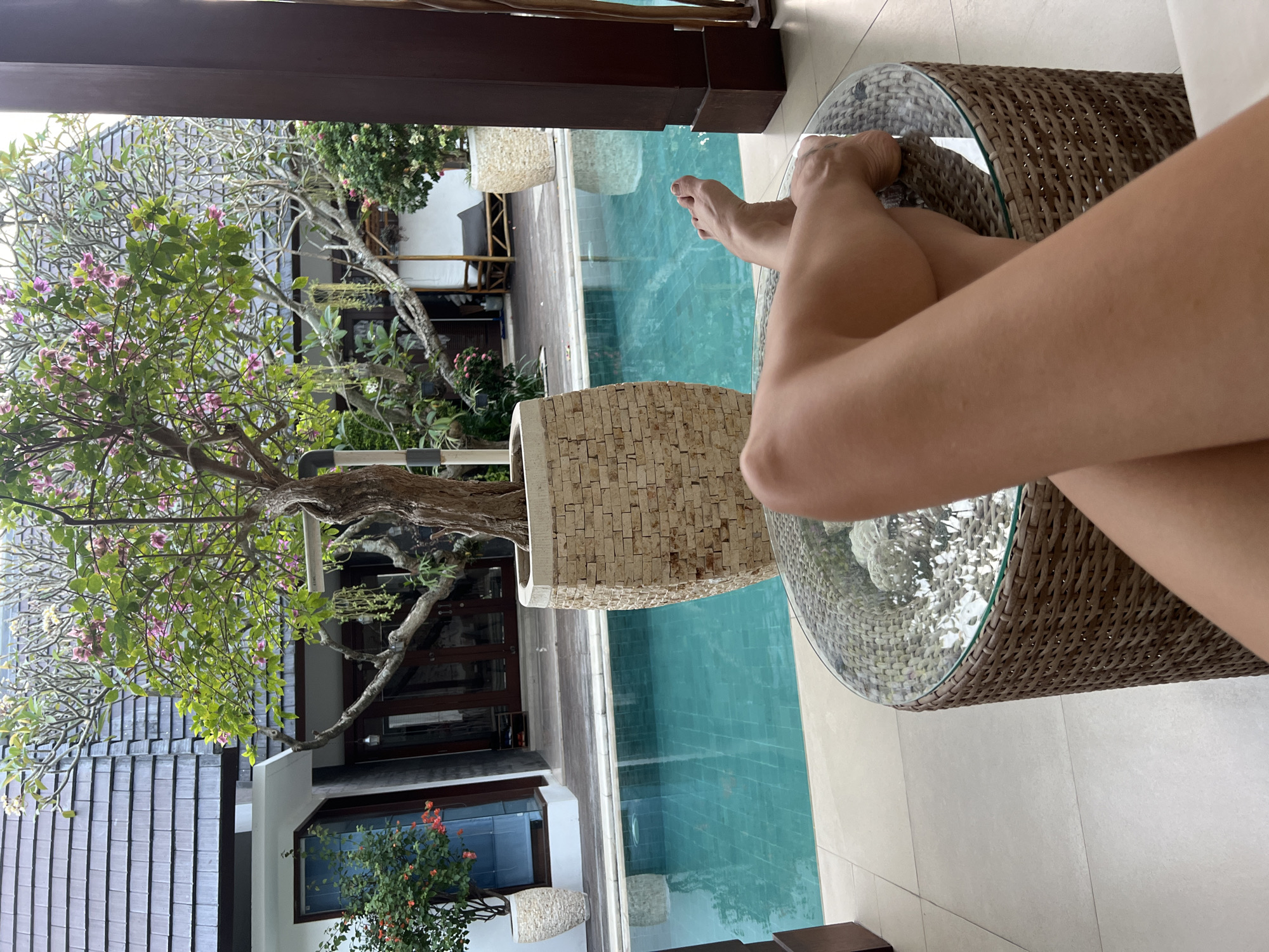 Woman relaxes poolside in North Kuta resort area