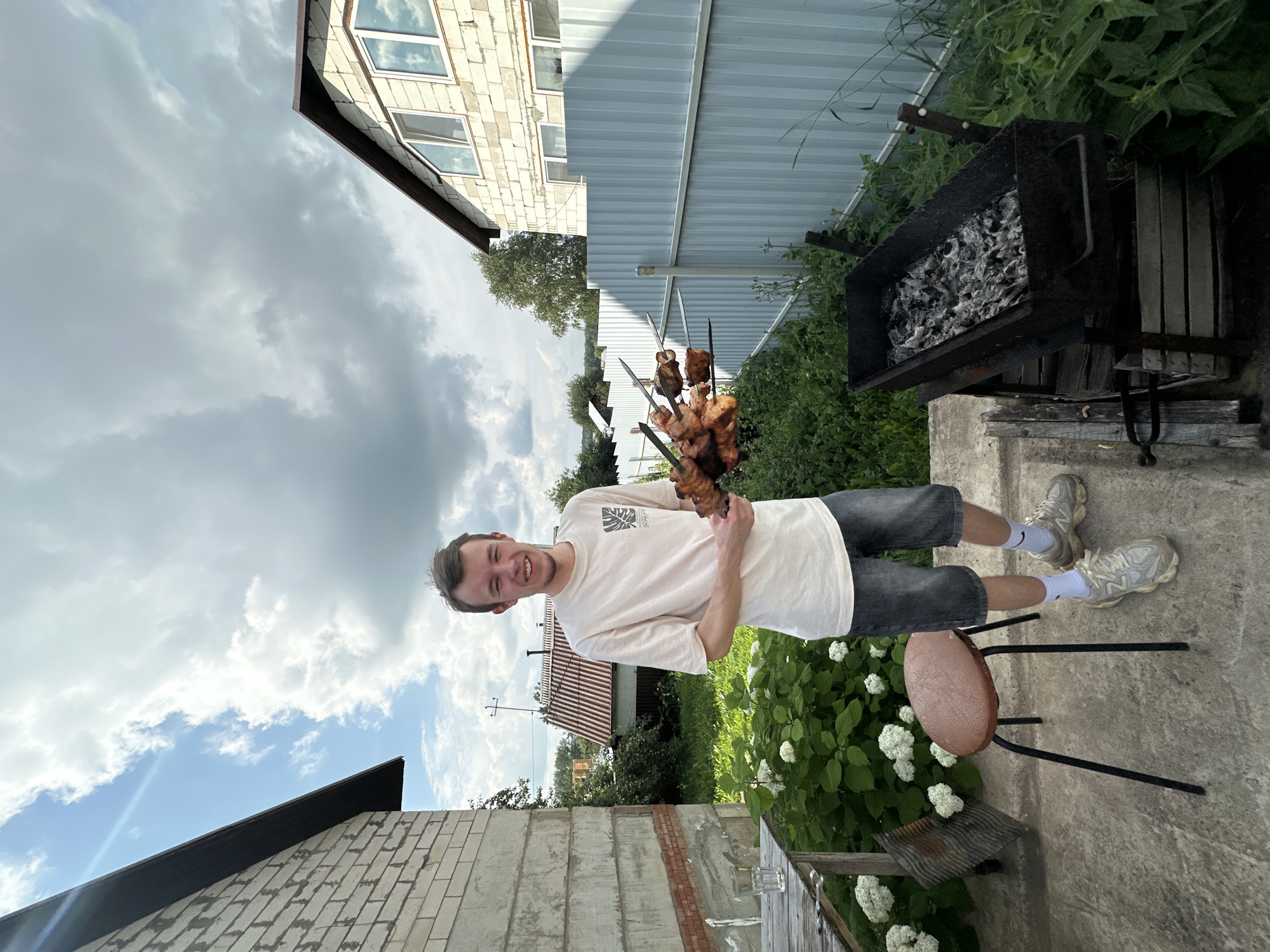 Backyard shashlik cookout in Chaikovsky with a German Shepherd in tow