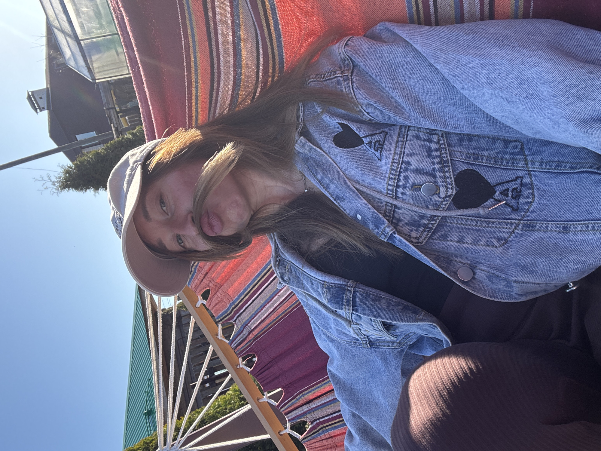Woman enjoys afternoon hammock time and bubble-blowing in Russian backyard