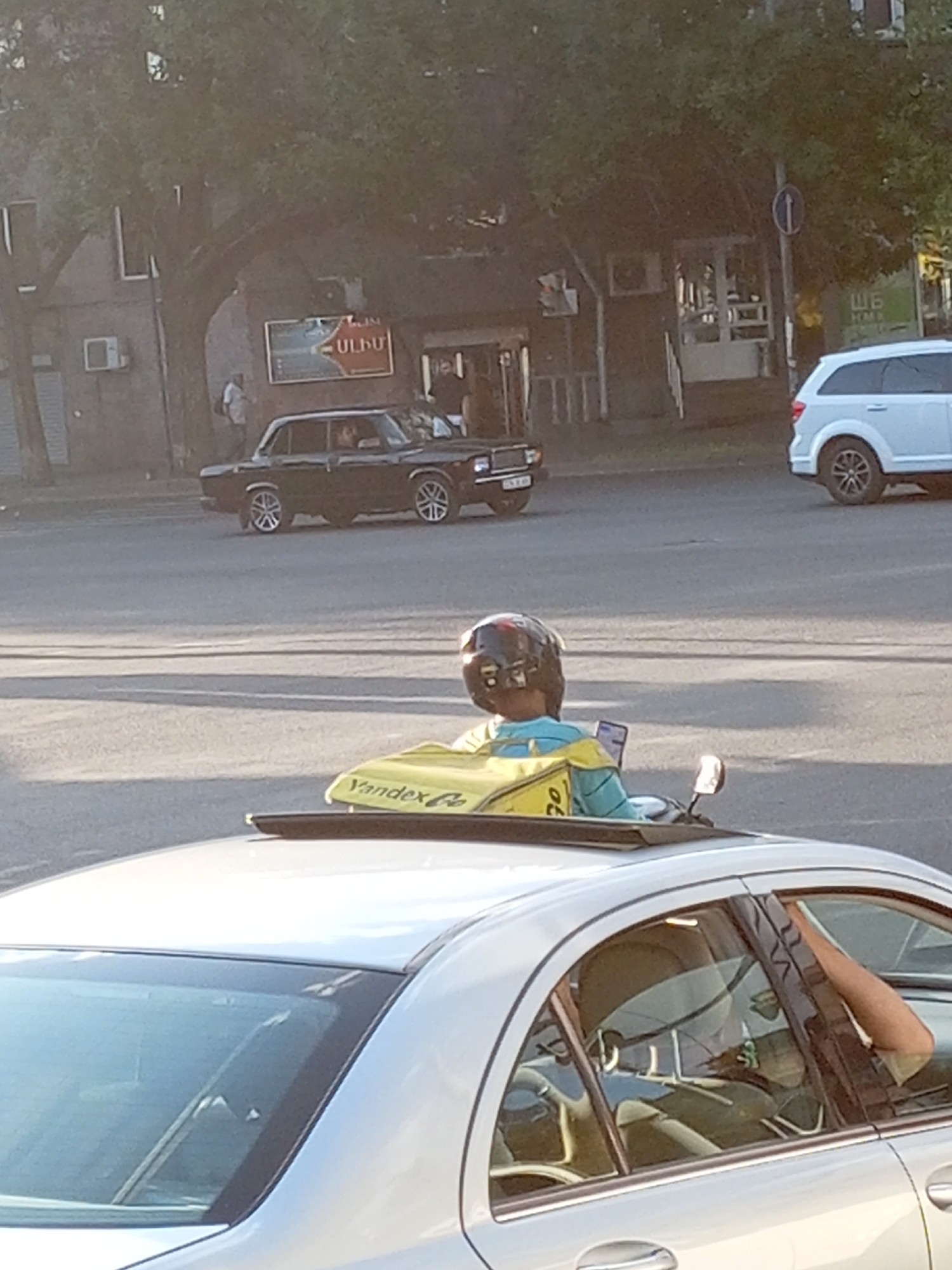 Yandex.Go delivery scooter navigates Yerevan streets midday