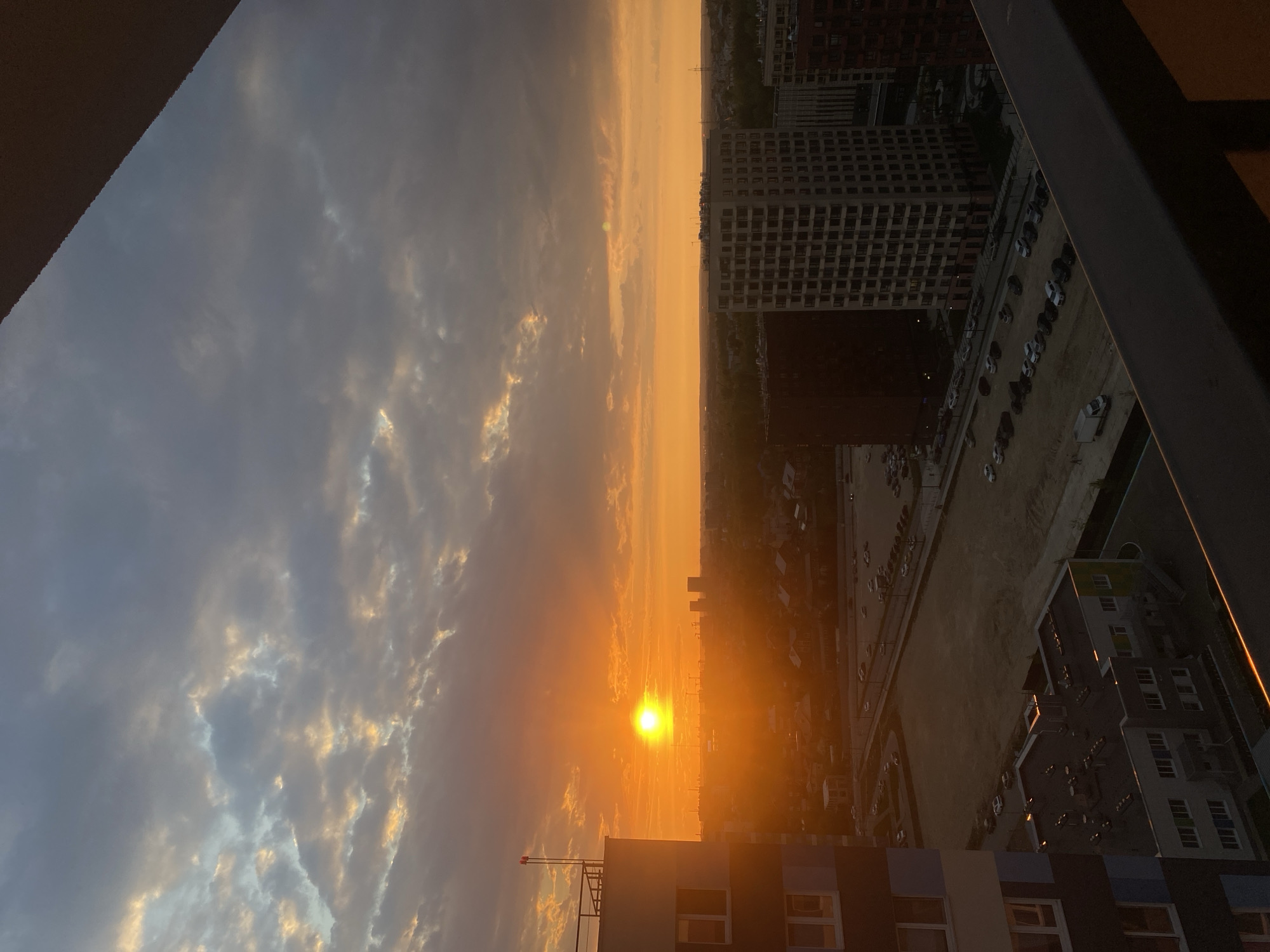 Orange sunset illuminates Russian cityscape with construction sites