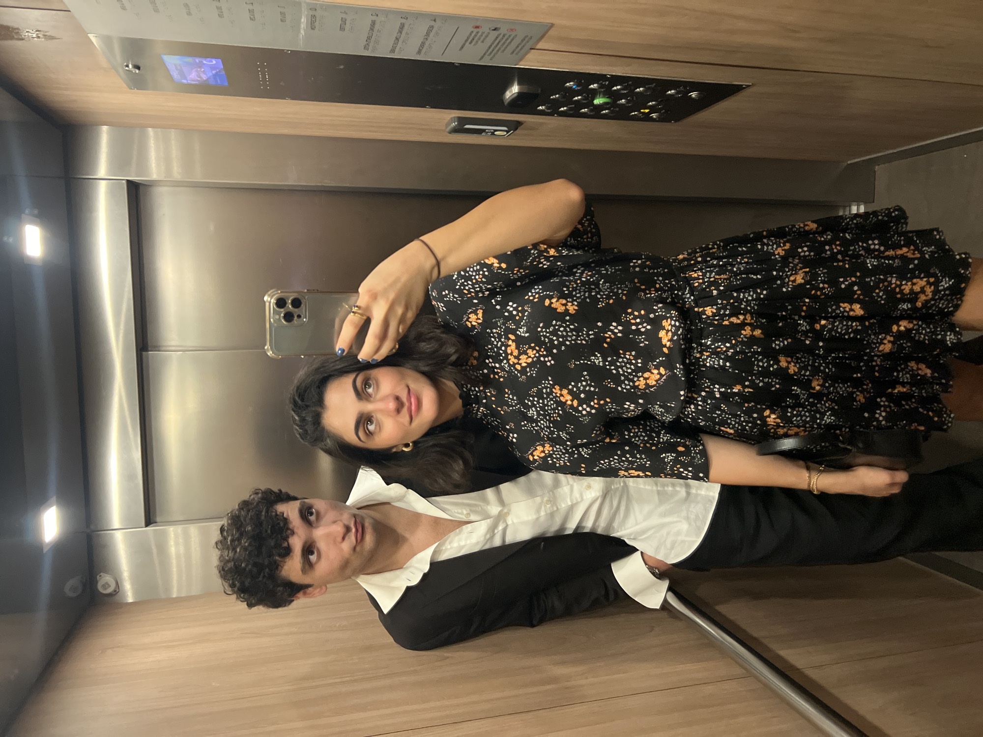 Mirror selfie in a wood-paneled Paris elevator
