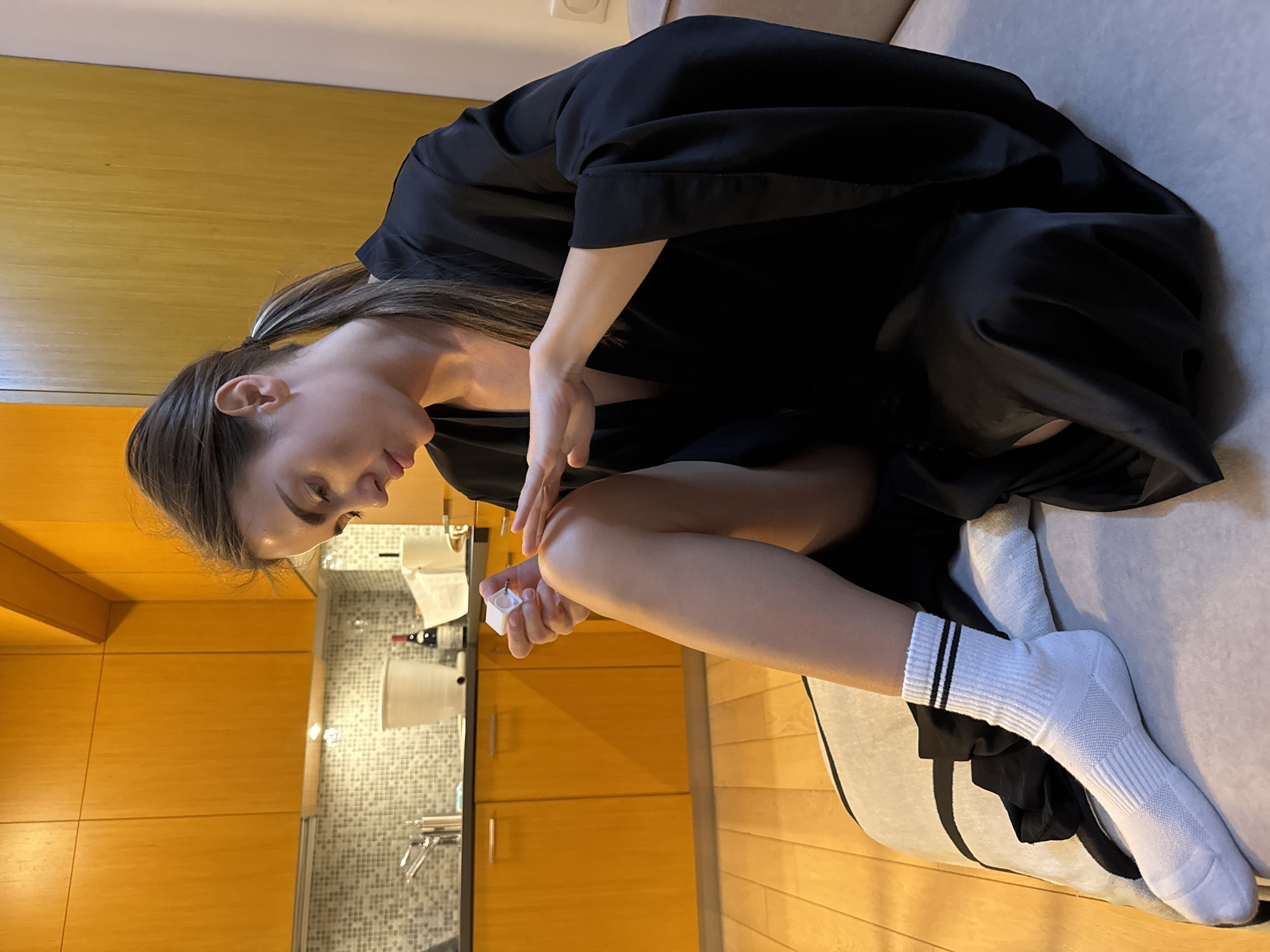 Woman applies lotion in Warsaw apartment evening routine