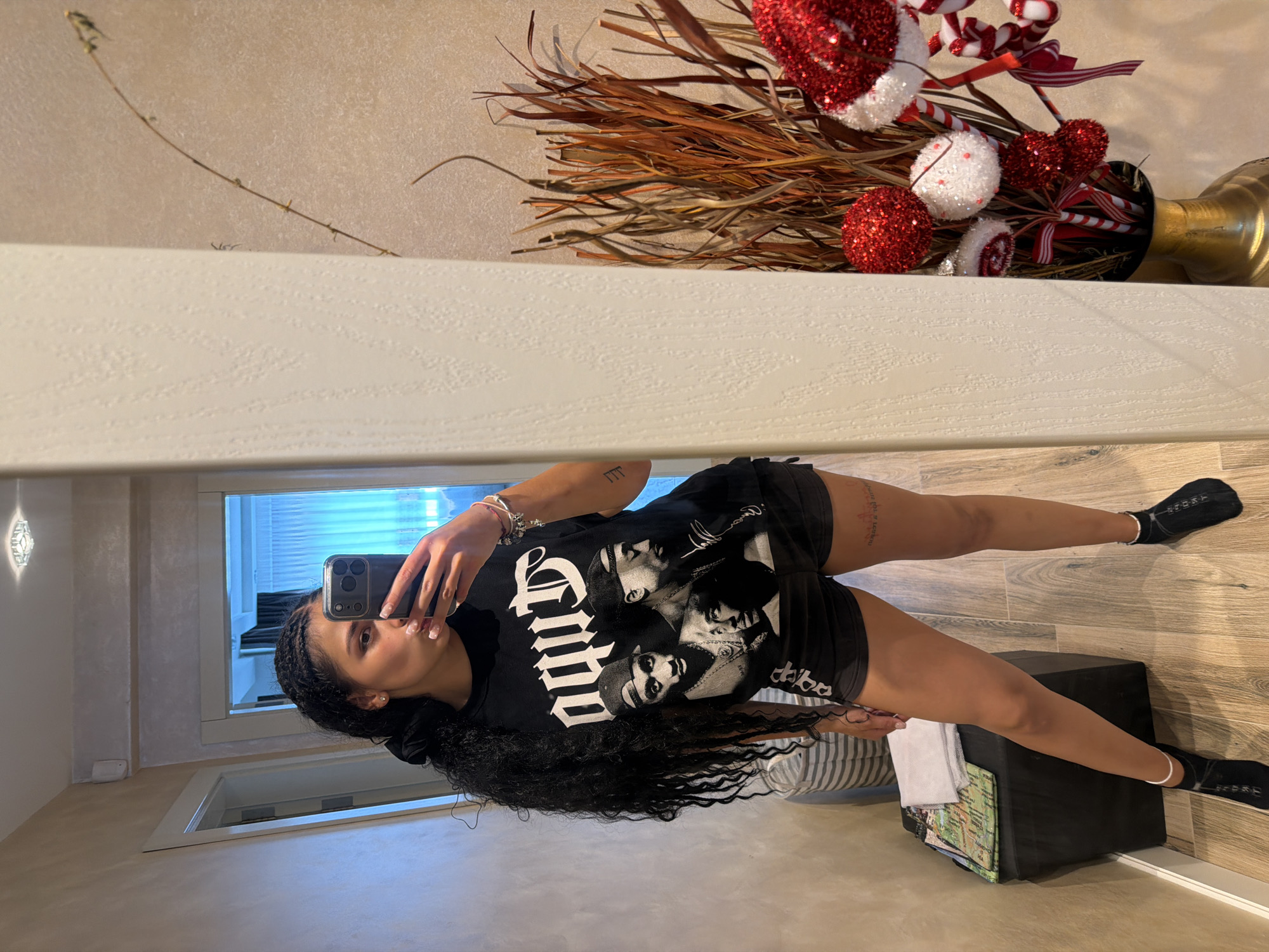 Mirror selfie in Gabrovo hallway, hip-hop graphic tee front and center