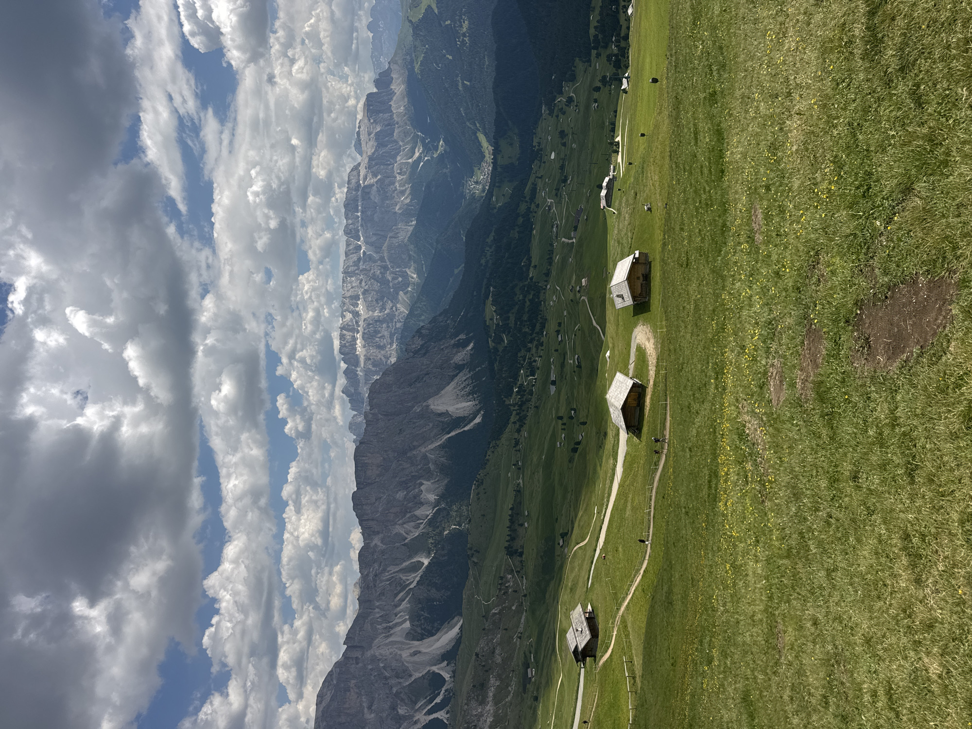 Dolomite meadows, chalets, and peaks on a summer afternoon