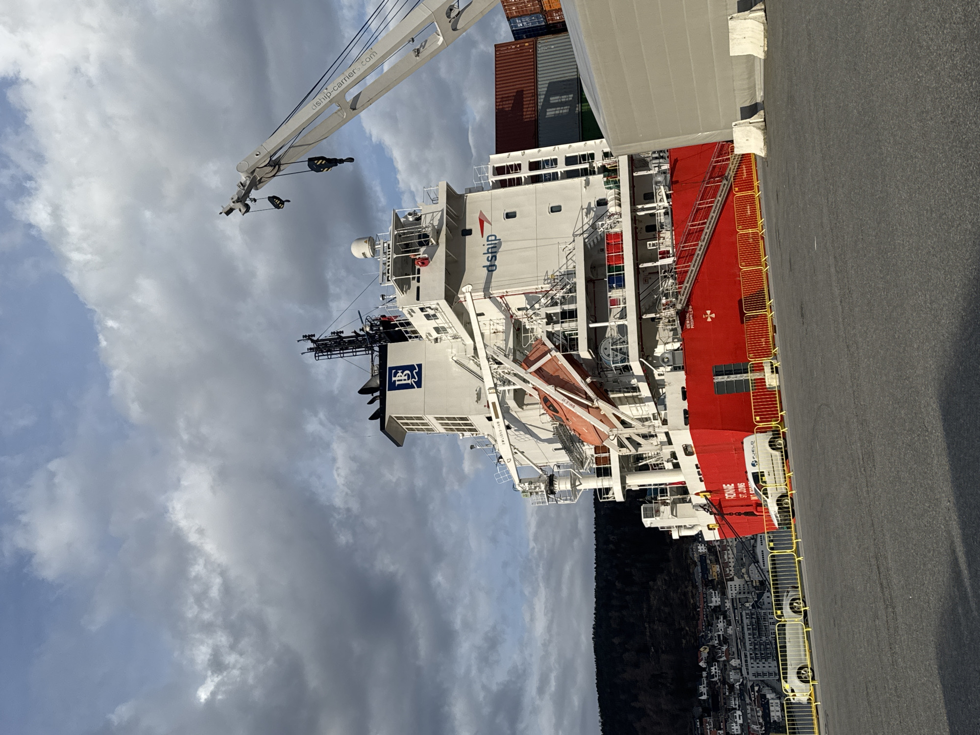 Cargo ship with dship logo docked at Bergen pier