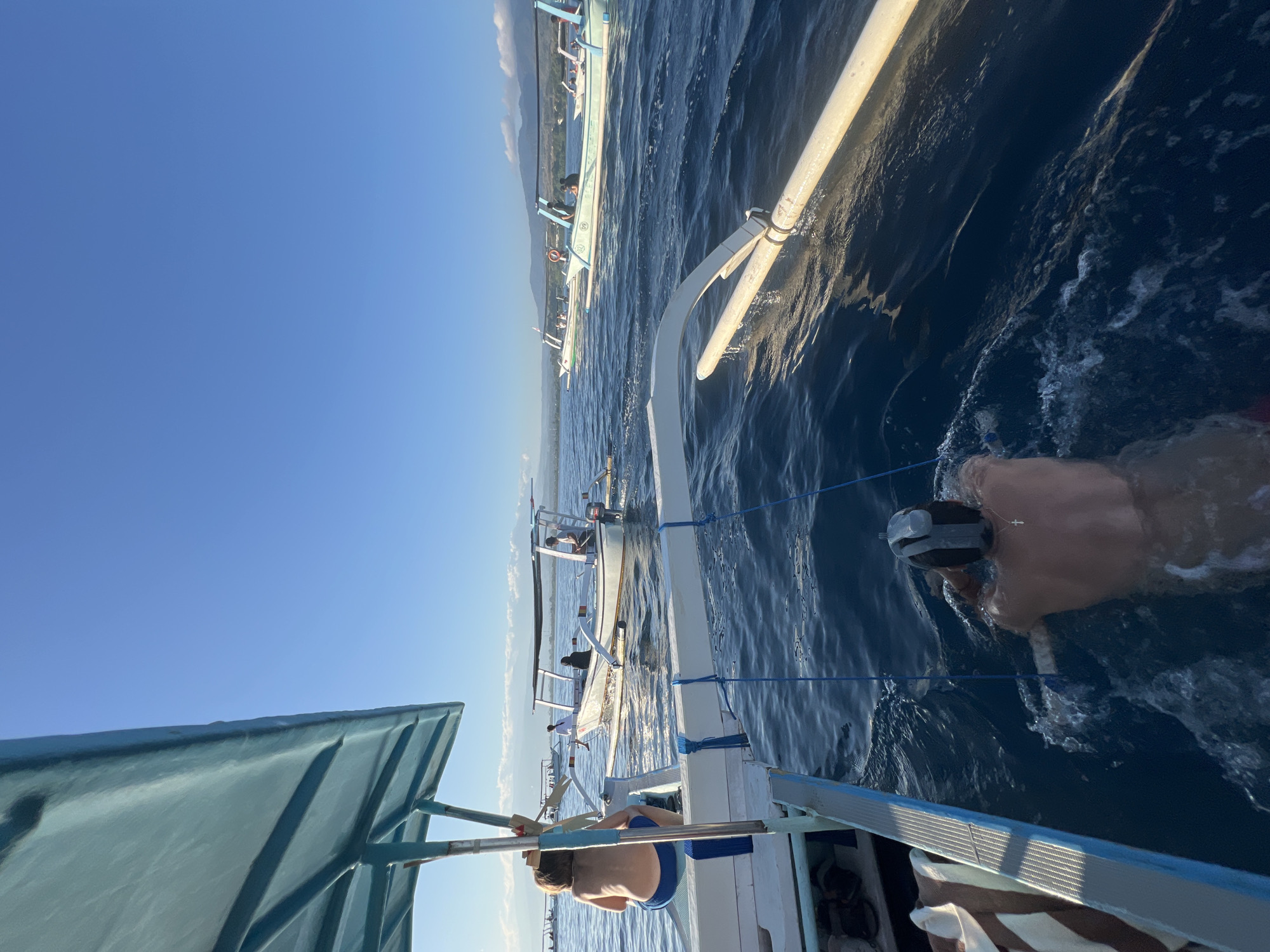 Traditional outrigger boats ferrying passengers on Indonesian coastal waters