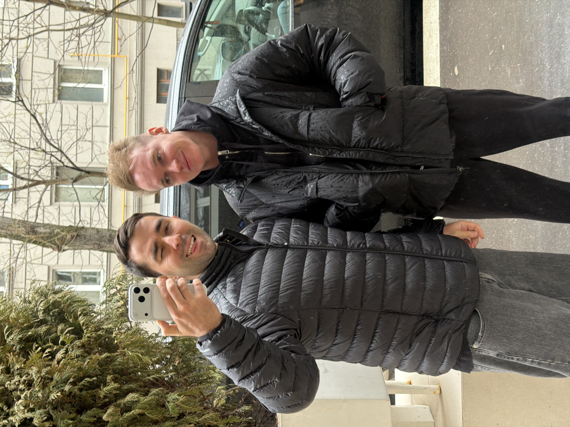 Two men take smiling selfie outdoors in Moscow