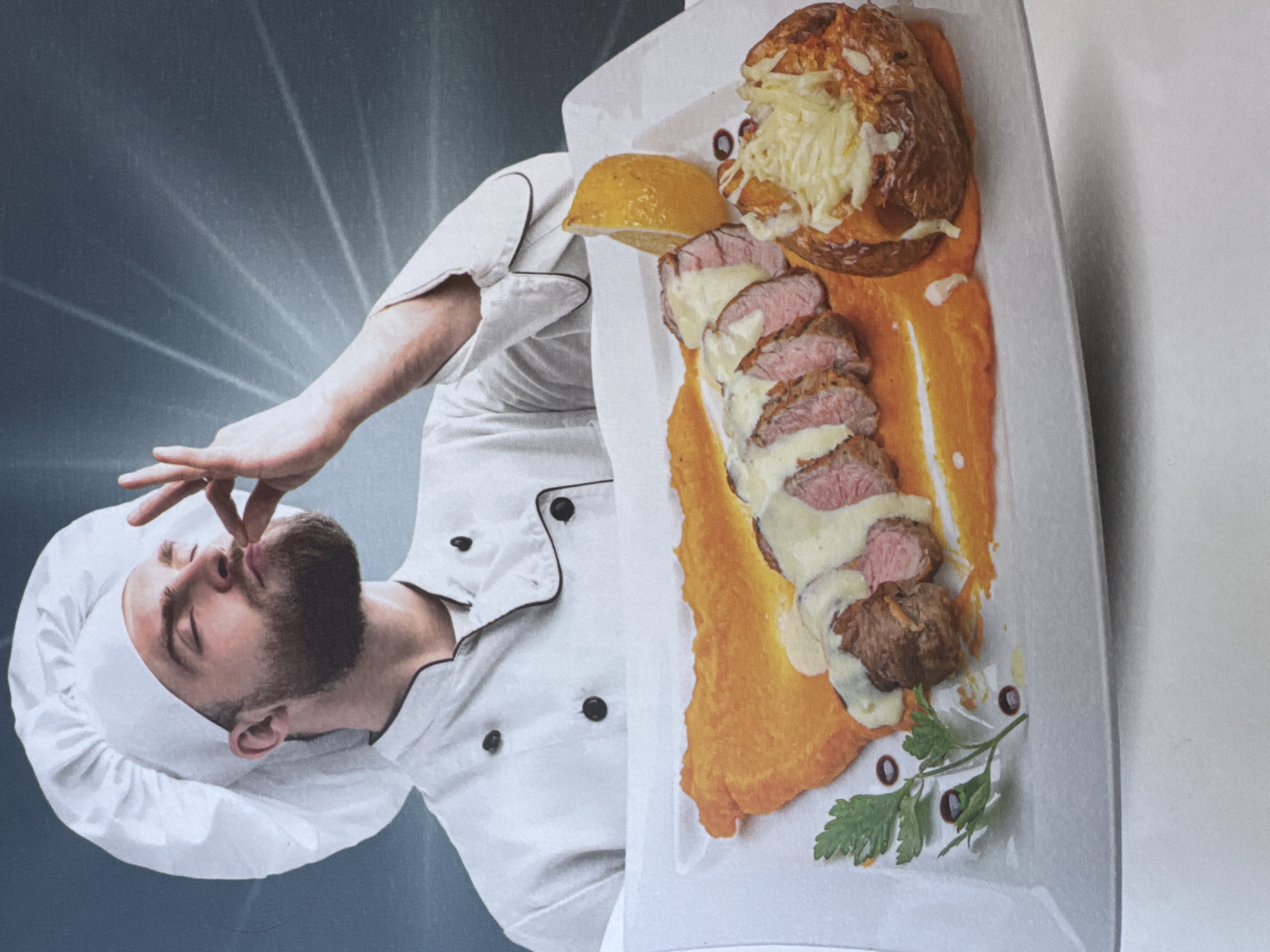 Chef photographed with plated dish showing culinary satisfaction