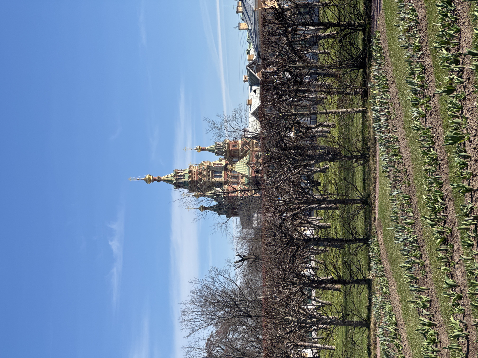 Tourist documents Peterhof Palace architecture and fountains during midday visit
