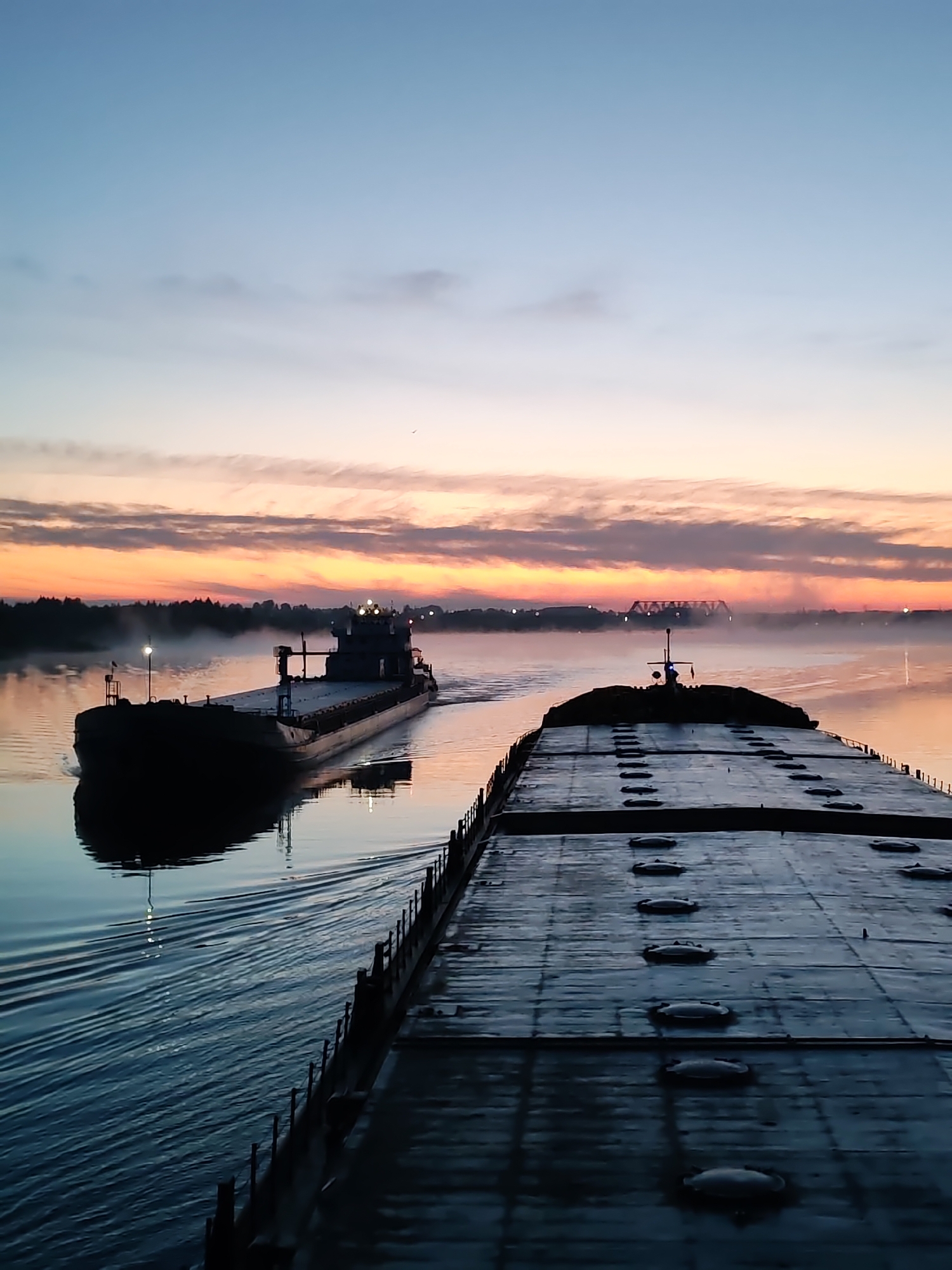 River barges navigate Russian waterways at twilight near Chagino