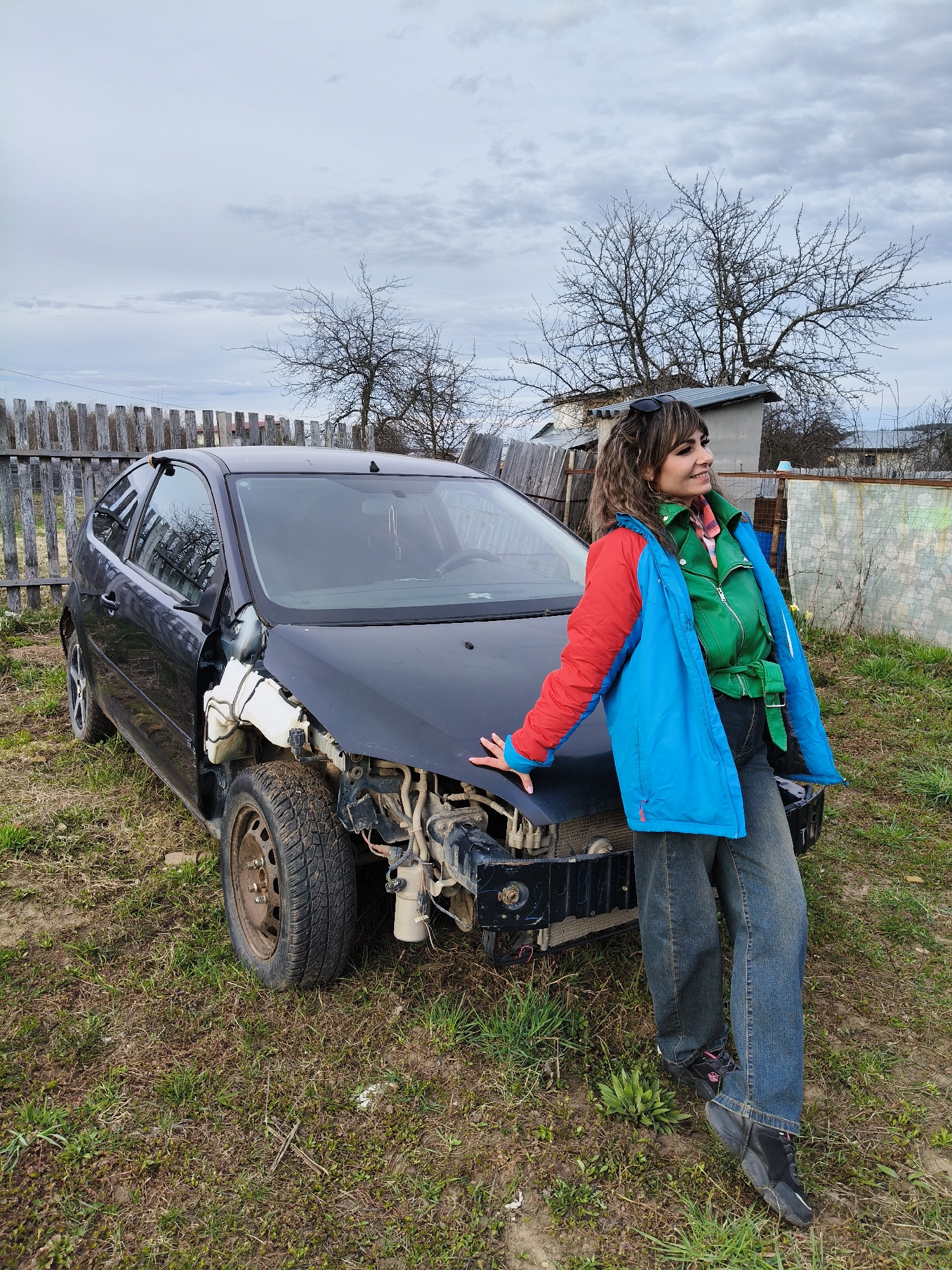 Women documented near damaged car in Chaikovsky, Russia