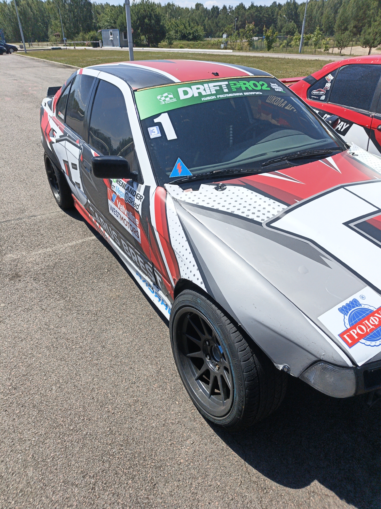 Race car livery detail, white and red with sponsor graphics