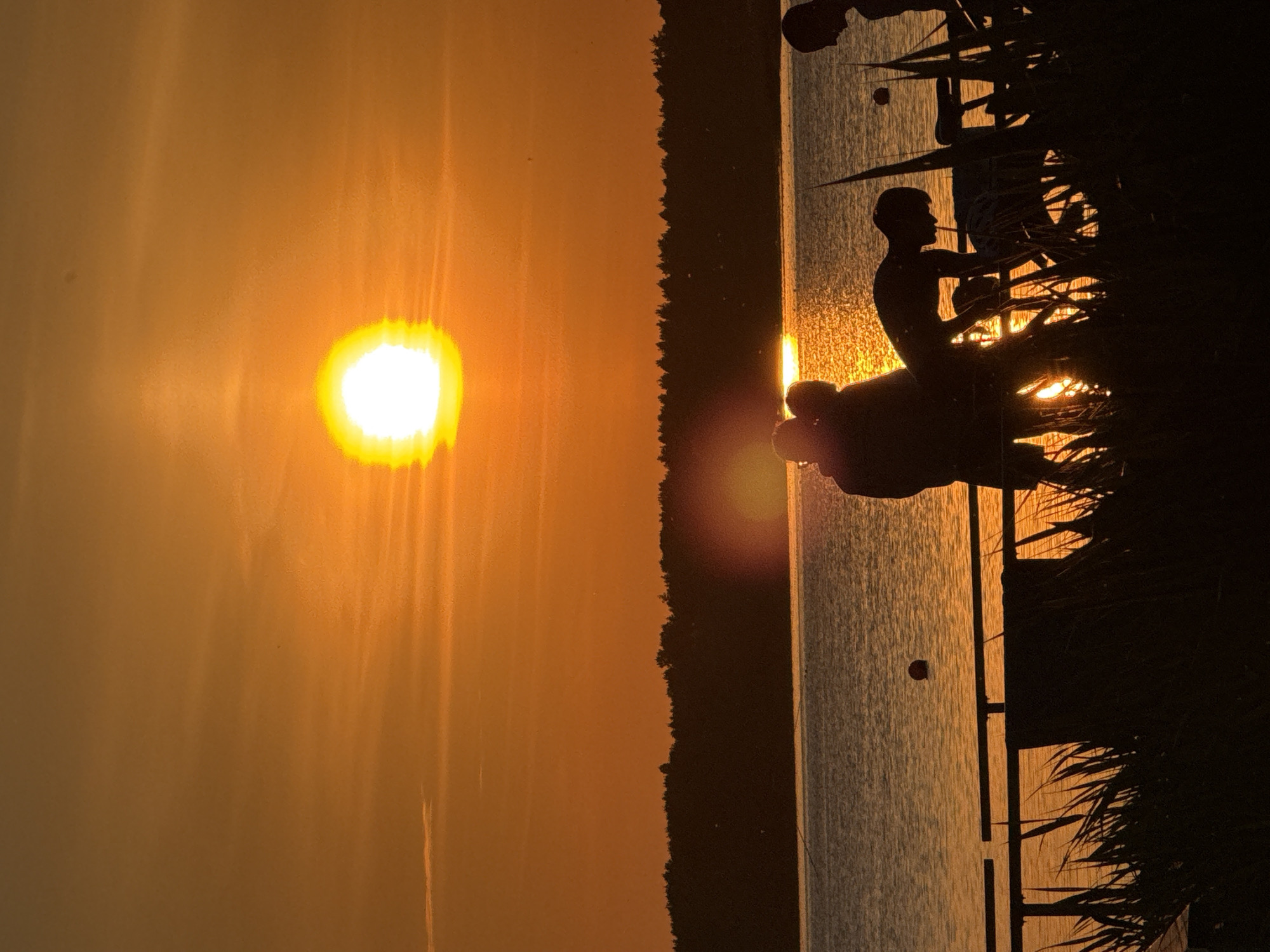 Sunset over water captured from wooden pier in Tiskre
