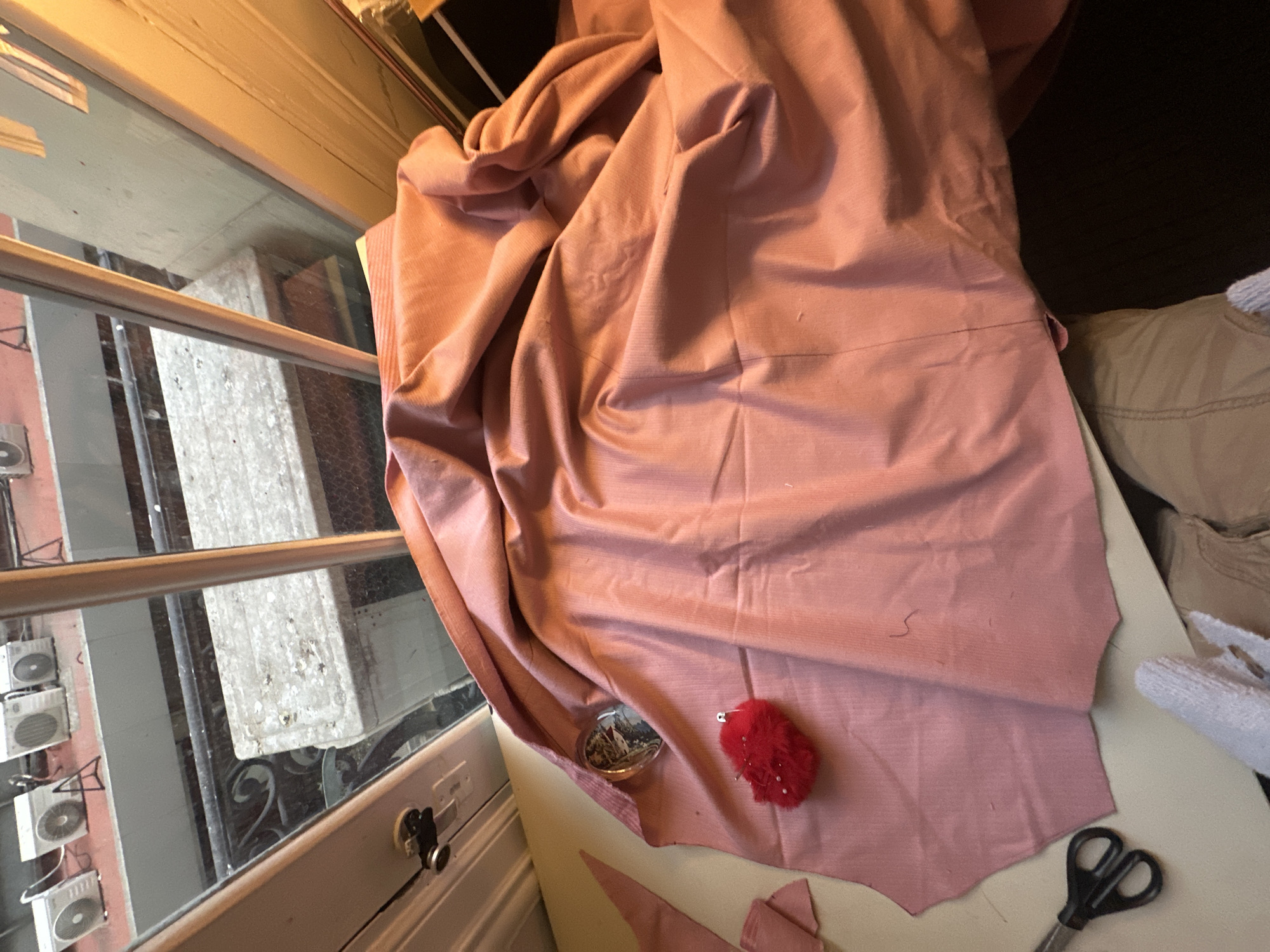 Buenos Aires resident examines wrinkled corduroy fabric indoors