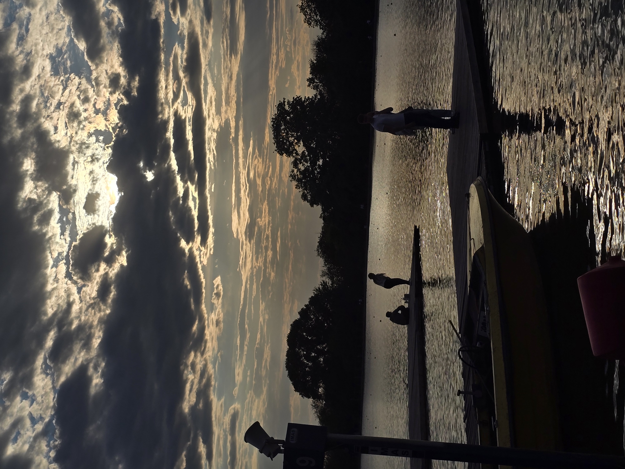 Kayaker paddled lake waters under dramatic evening skies