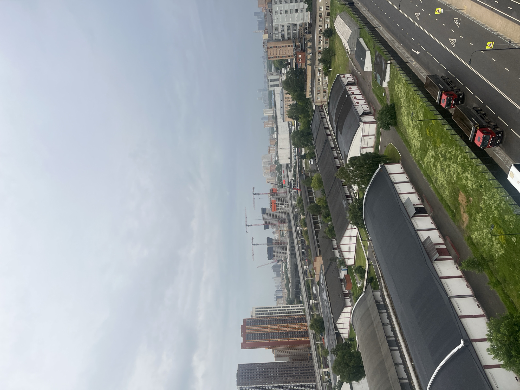 Red dump trucks move through Mytishchi's industrial outskirts