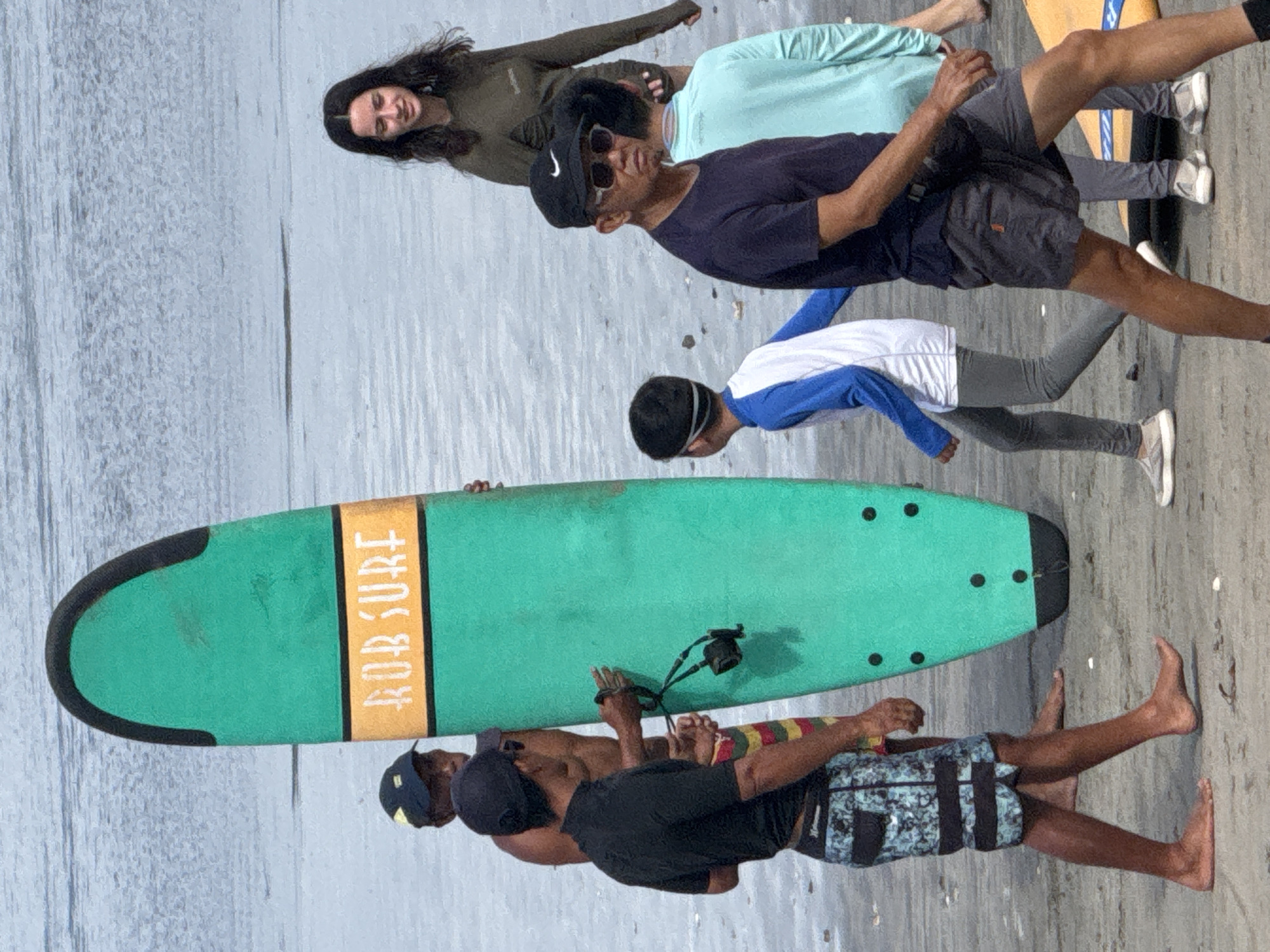Surf lessons and beach activity along Kuta's shoreline