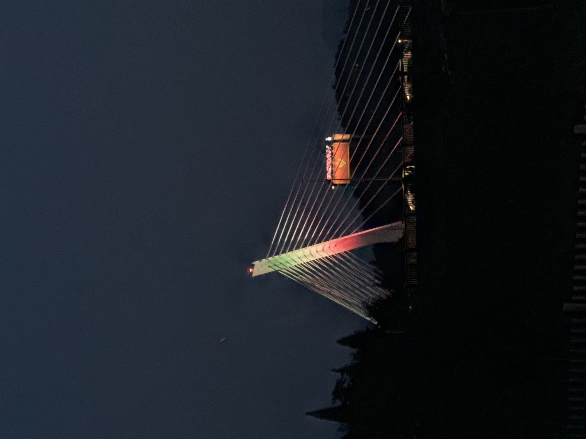 Millennium Bridge displays green-red lights in Podgorica nighttime scene