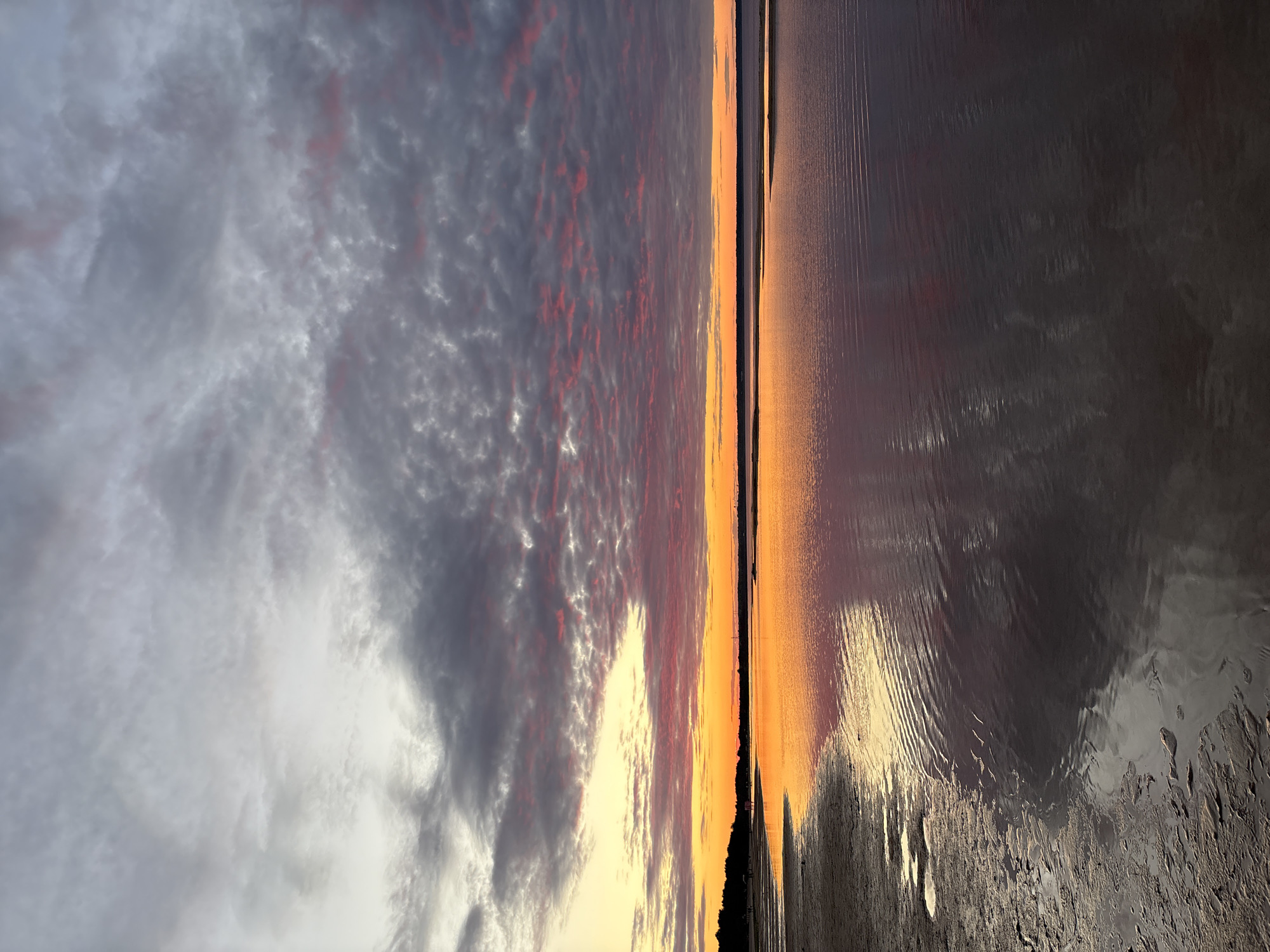 Sunset on Lake Ladoga with signs of a lakeside camp nearby