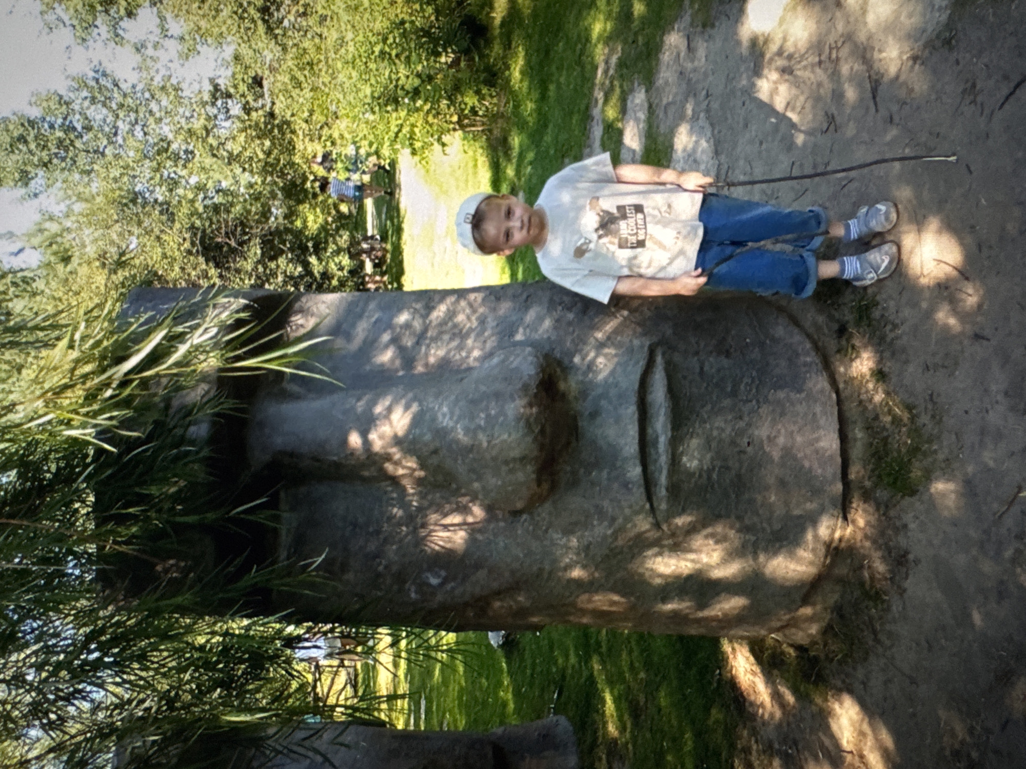 Boy rests on Moai-style sculpture in Solikamsk, Russia