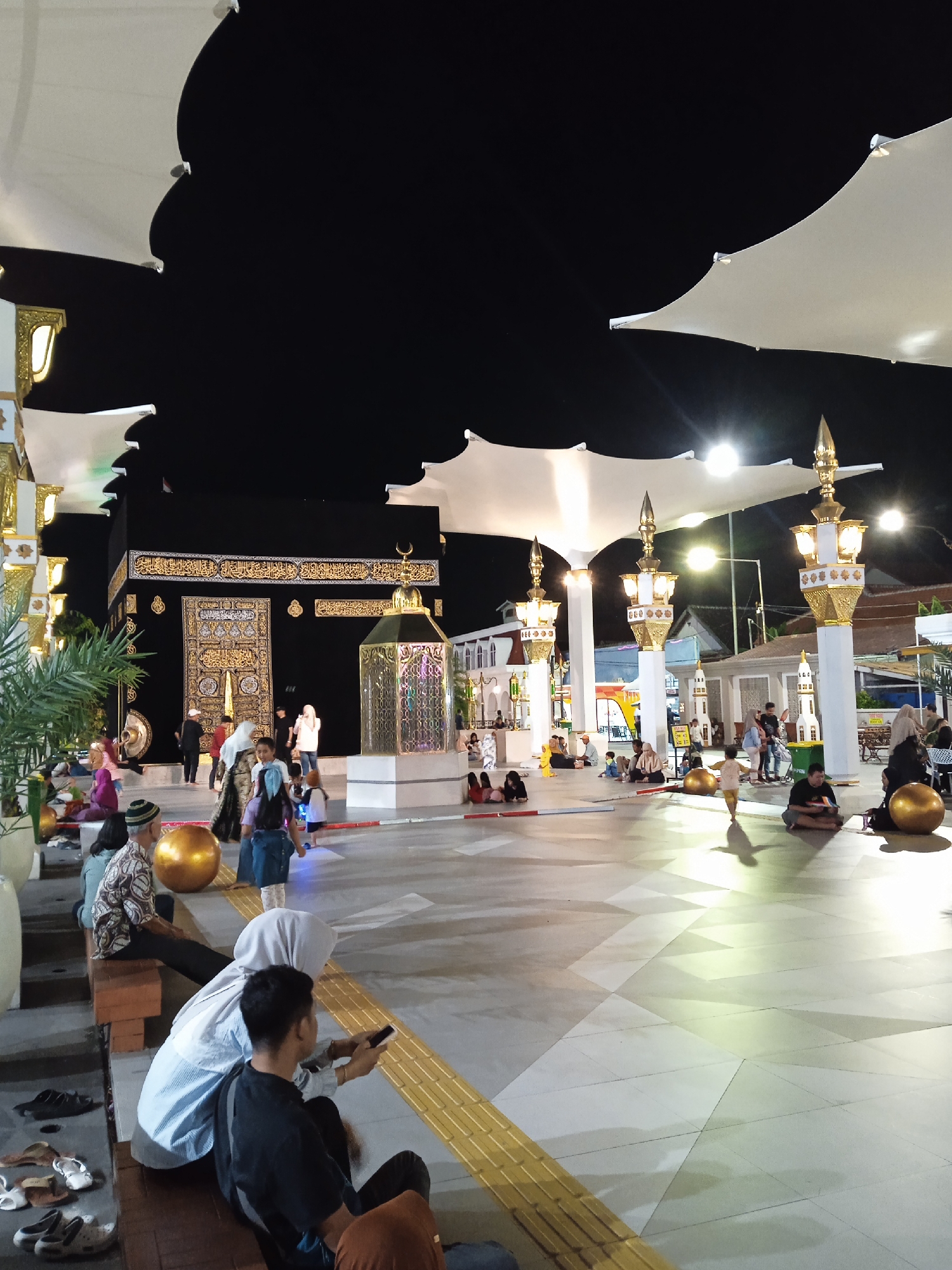 Families gather at illuminated cultural plaza in Madiun, Indonesia