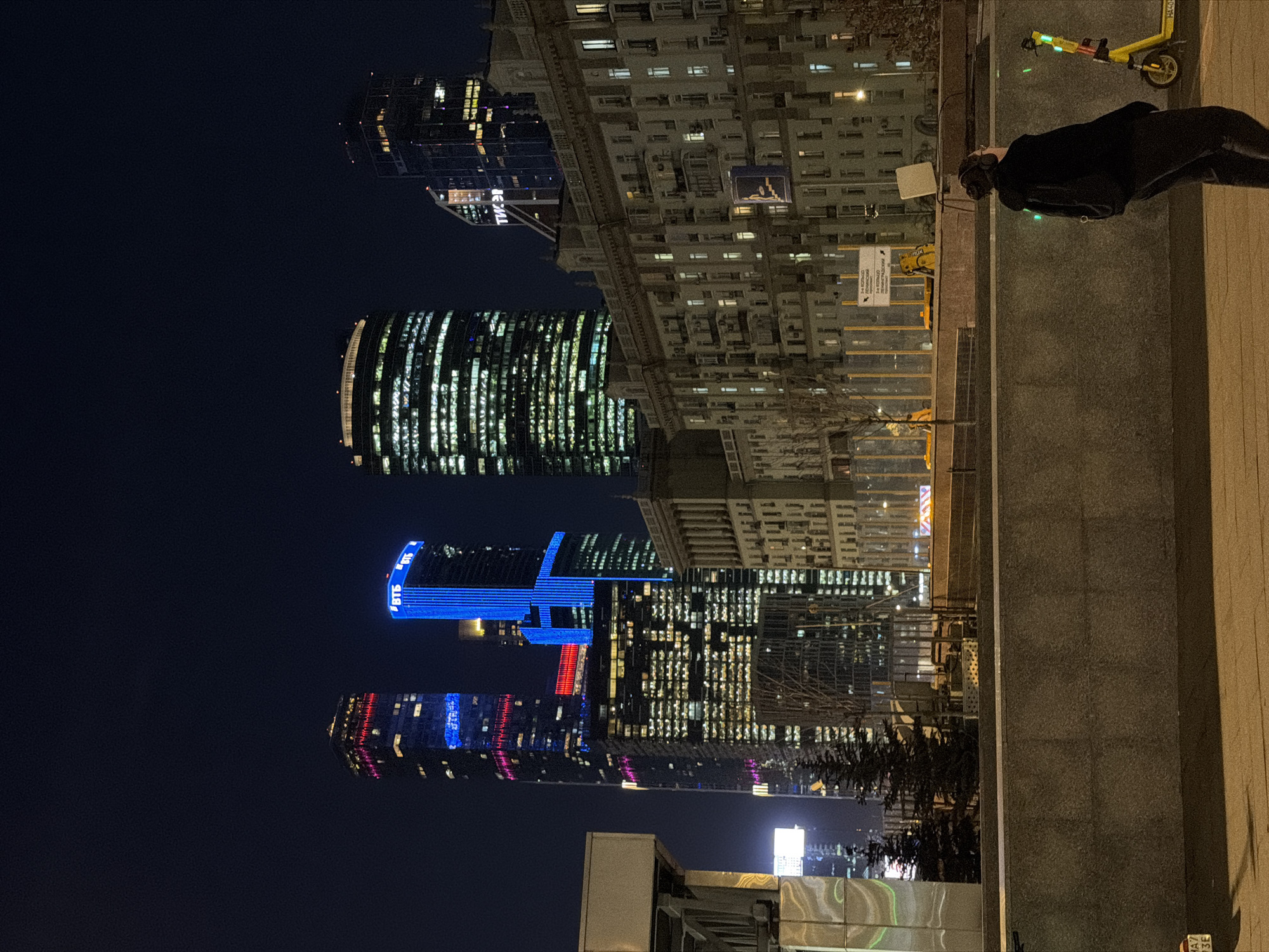 Moscow skyscrapers illuminate night sky with colorful architectural lighting