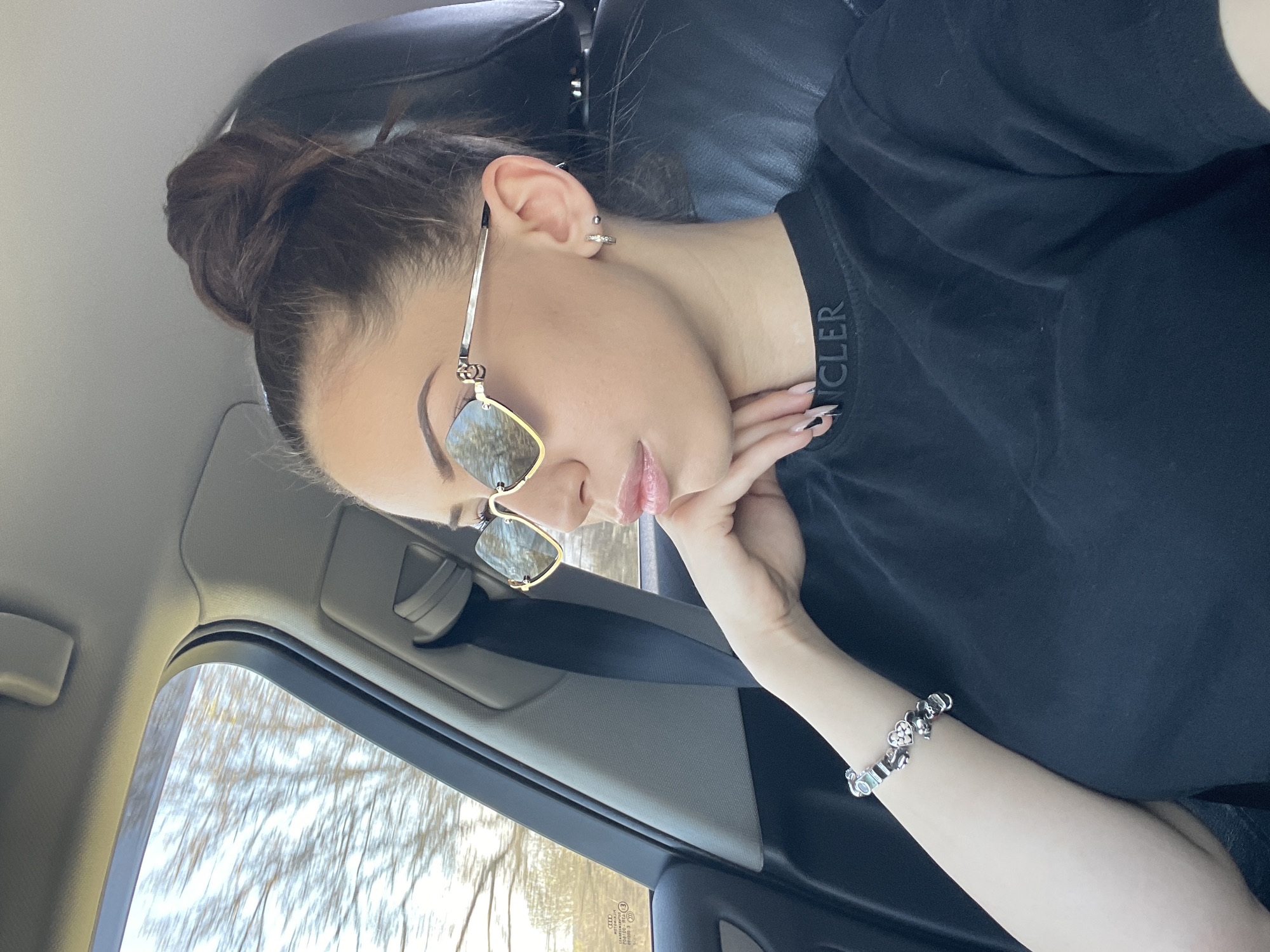 Woman in Moncler shirt observed sitting in car in Bulgaria