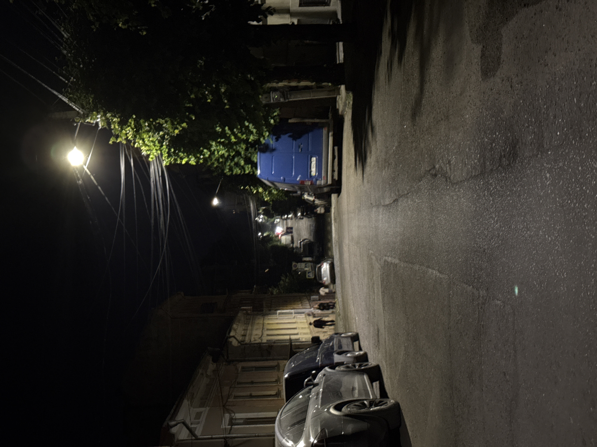 Nighttime streets of Chernivtsi, cobblestones and parked cars