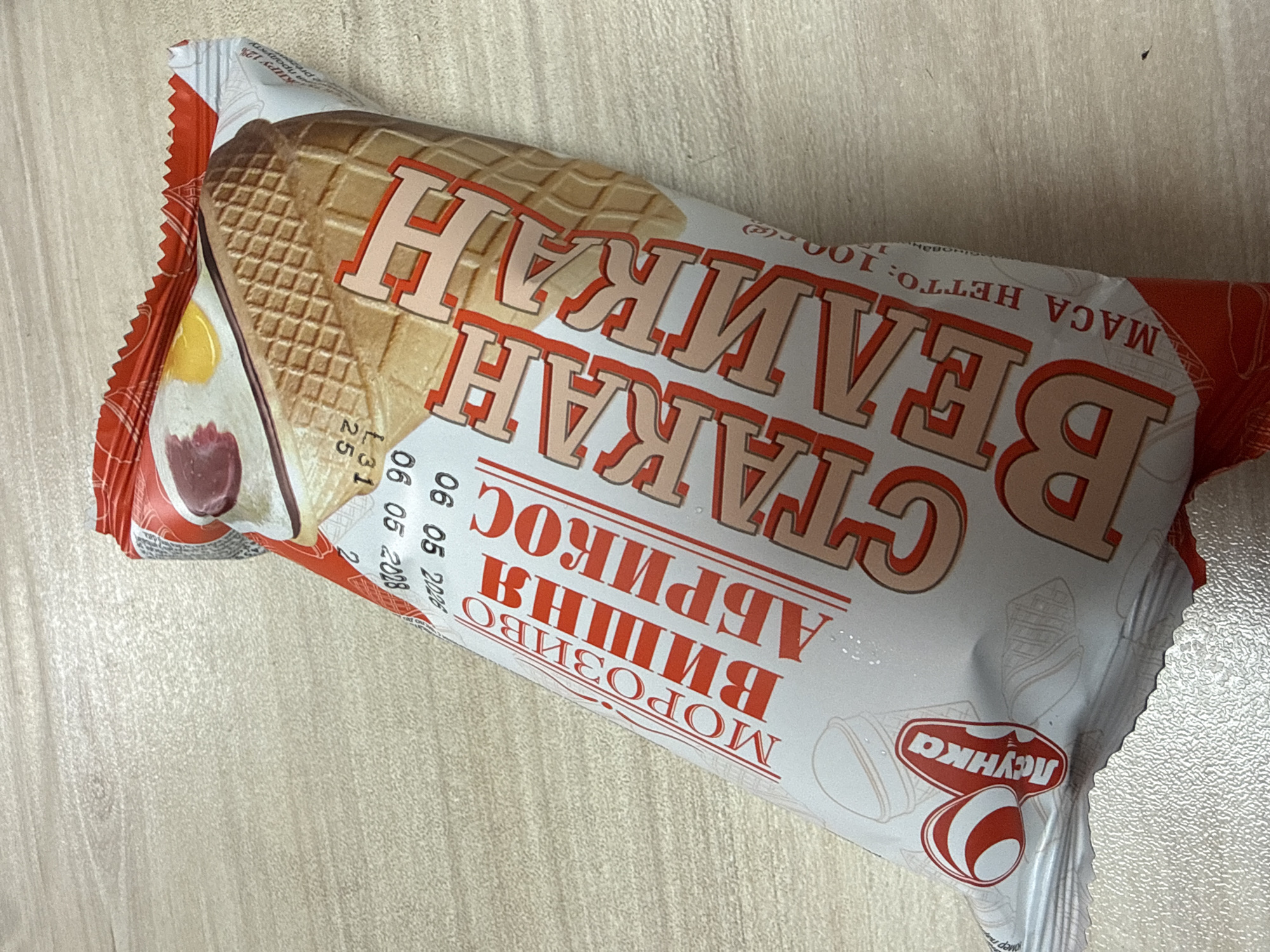 Unwrapped ice cream bar with Russian-labeled packaging, Aksakovo